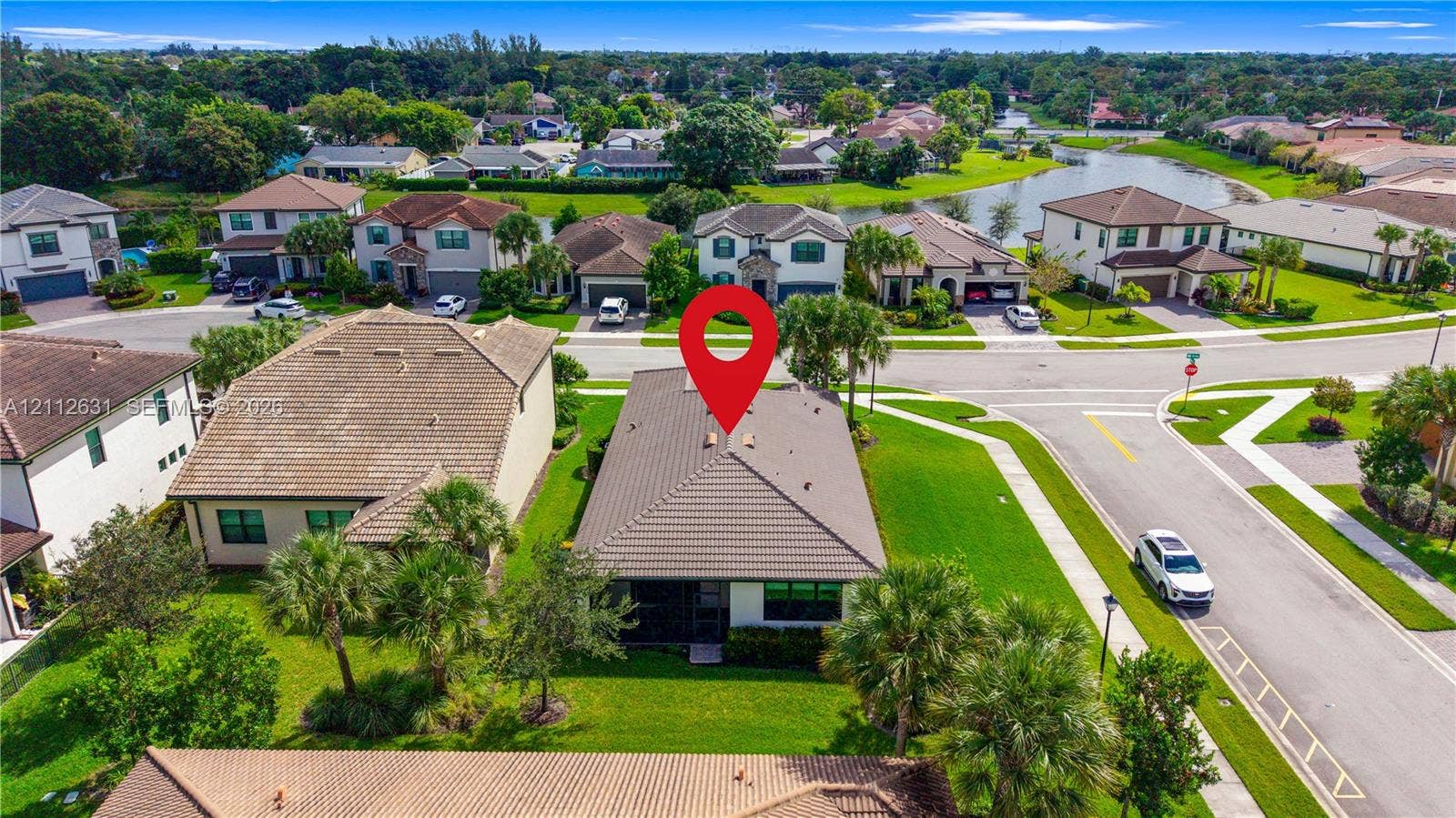 8257 NW 79th Avenue, Tamarac, FL 33321 Single-story residence featuring a tile roof, light-toned exterior finish, and a corner lot location with curated landscaping