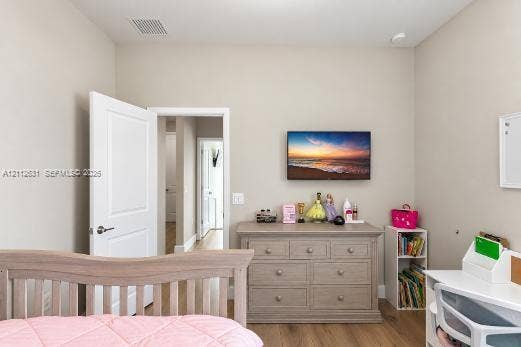 8257 NW 79th Avenue, Tamarac, FL 33321 Neutral wall tones, wood-finish flooring, and a six-panel interior door