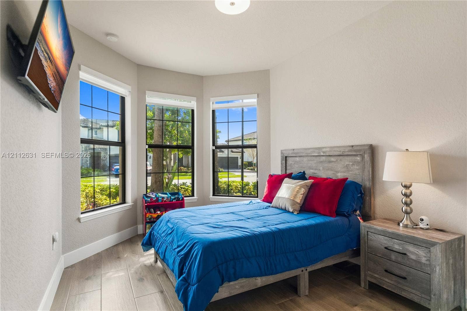 8257 NW 79th Avenue, Tamarac, FL 33321 Bay window featuring grid-pattern windows, wood-finish flooring, and recessed ceiling lighting