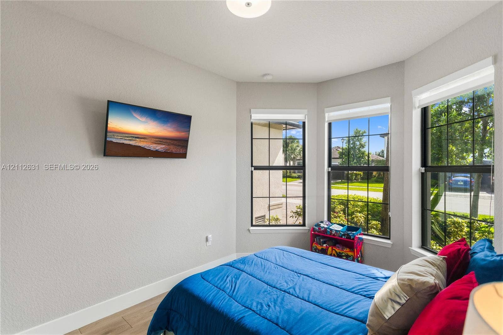 8257 NW 79th Avenue, Tamarac, FL 33321 Bay window featuring large dual-pane windows with dark frames, wood-finish flooring, and recessed ceiling lighting