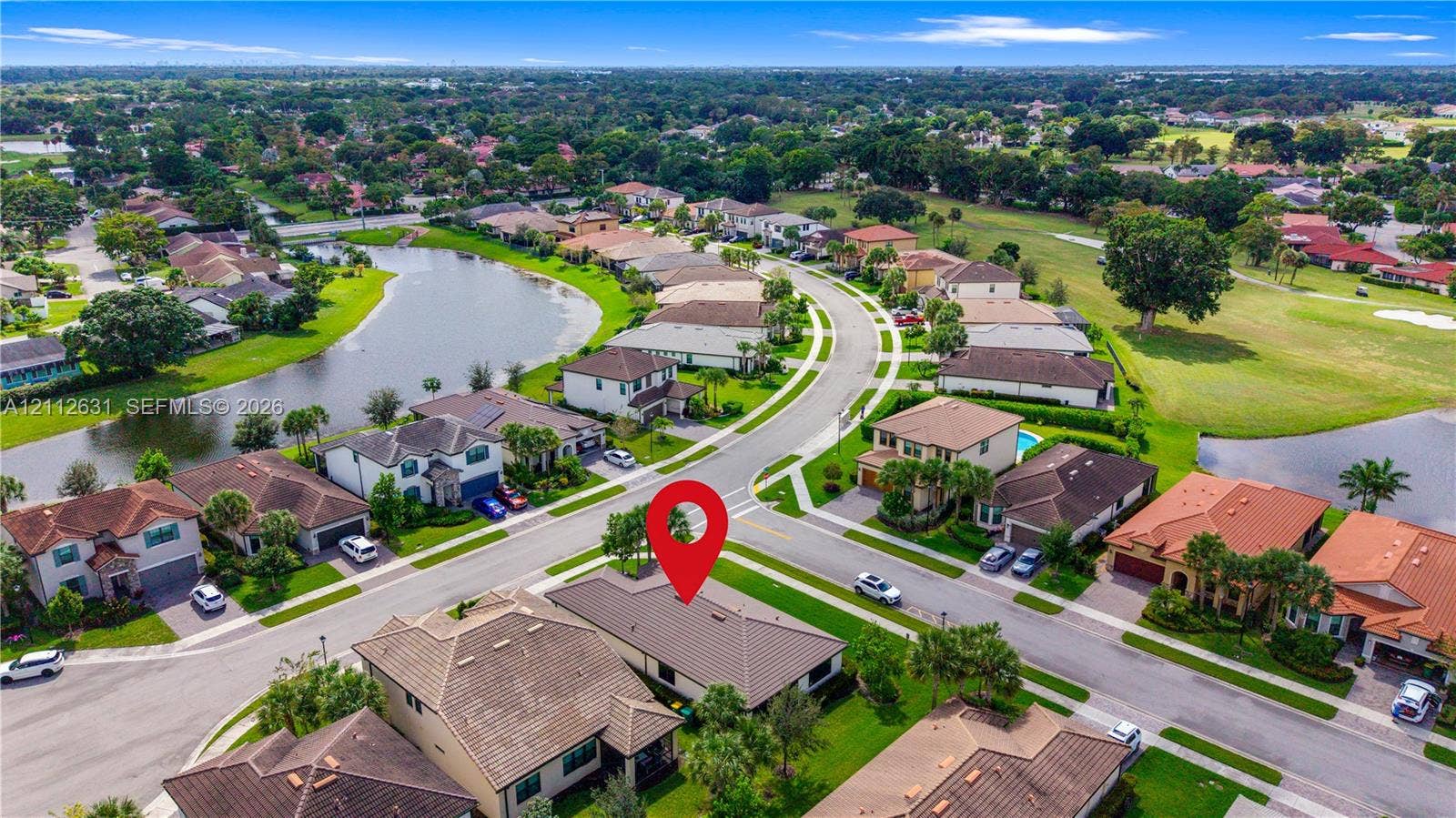 8257 NW 79th Avenue, Tamarac, FL 33321 Aerial perspective featuring a tile roof, concrete driveway, and established landscaping within a suburban community