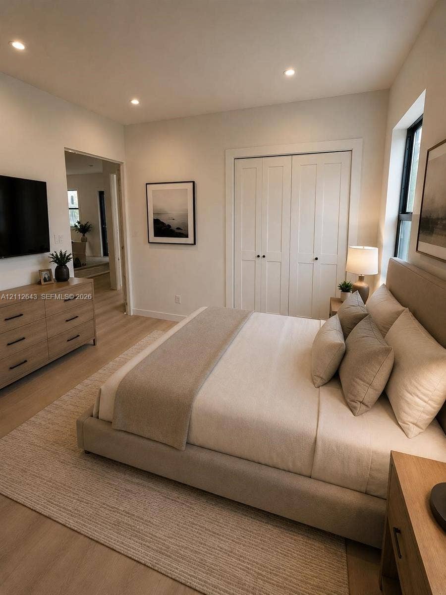1190 NW 57th Street, Miami, FL 33127 Neutral-toned interior featuring wood-finish flooring, recessed lighting, and double-panel closet doors