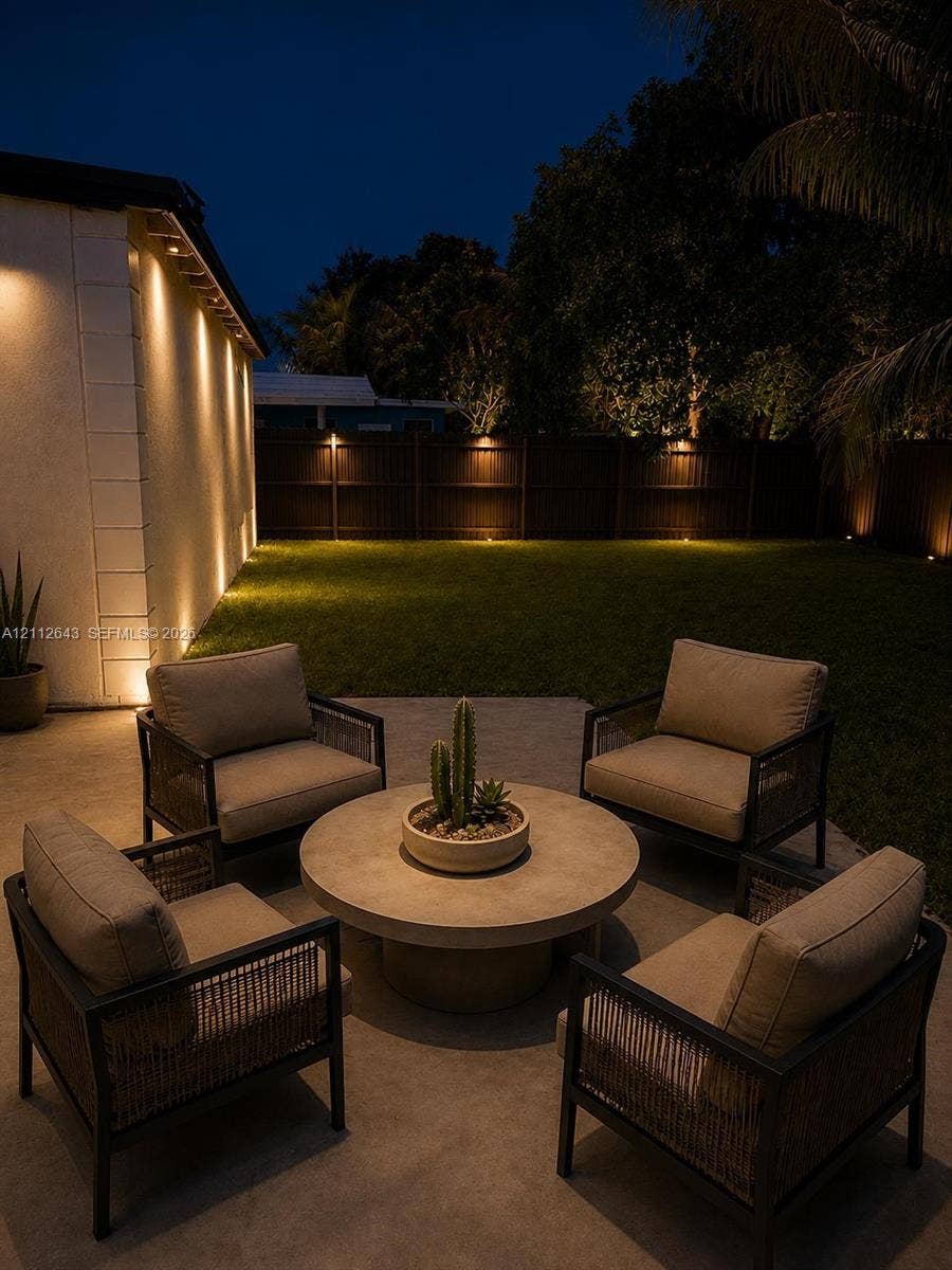 1190 NW 57th Street, Miami, FL 33127 Concrete patio featuring recessed wall lighting and a perimeter privacy fence