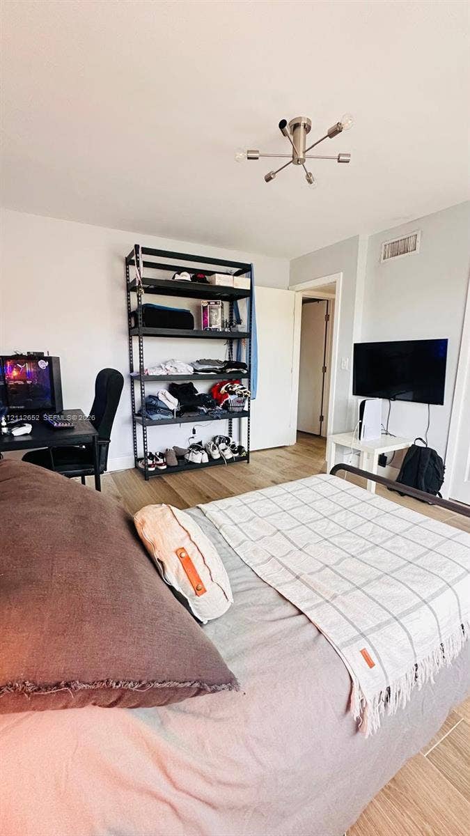 Wood-finish flooring, multi-arm sputnik ceiling light fixture, and solid core interior door