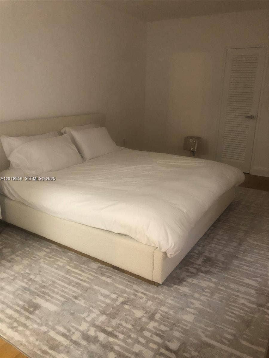 10185 Collins Avenue, #1016, Bal Harbour, Bal Harbour, FL 33154 Interior space featuring neutral wall tones and a louvered closet door