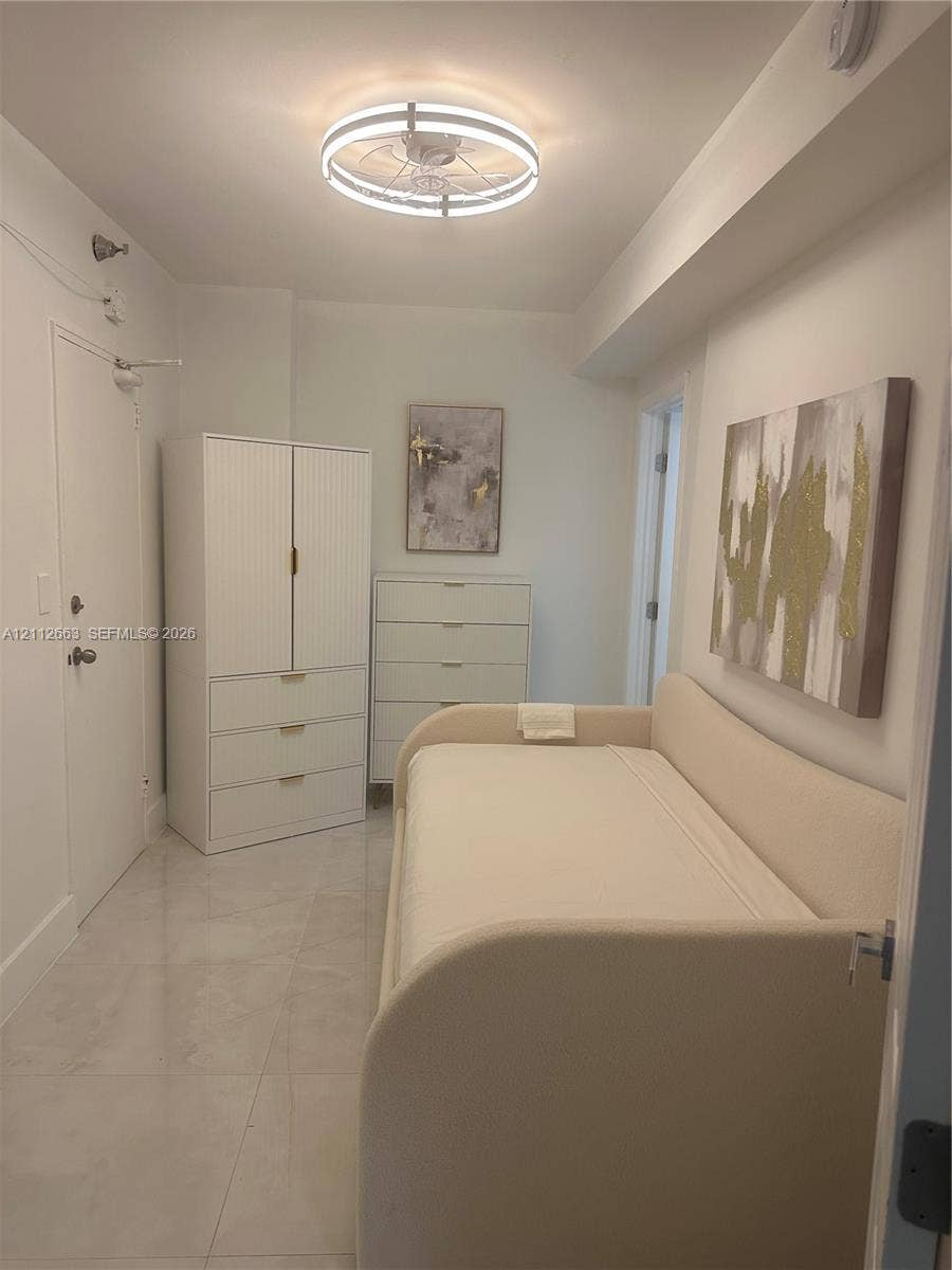 10185 Collins Avenue, #523, Bal Harbour, Bal Harbour, FL 33154 Room featuring large-format tile flooring and a circular flush-mount LED ceiling light fixture