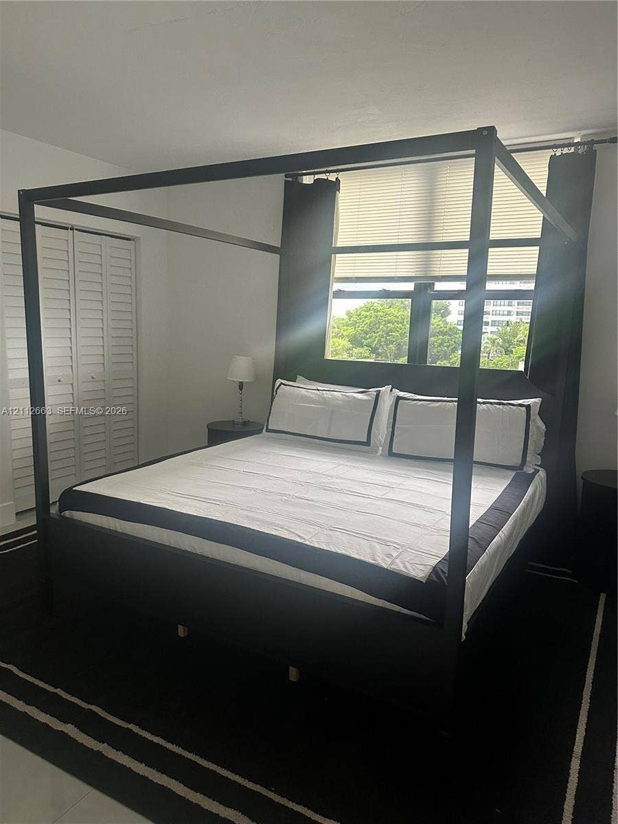 10185 Collins Avenue, #523, Bal Harbour, Bal Harbour, FL 33154 White louvered closet doors and a multi-pane window featuring horizontal blinds