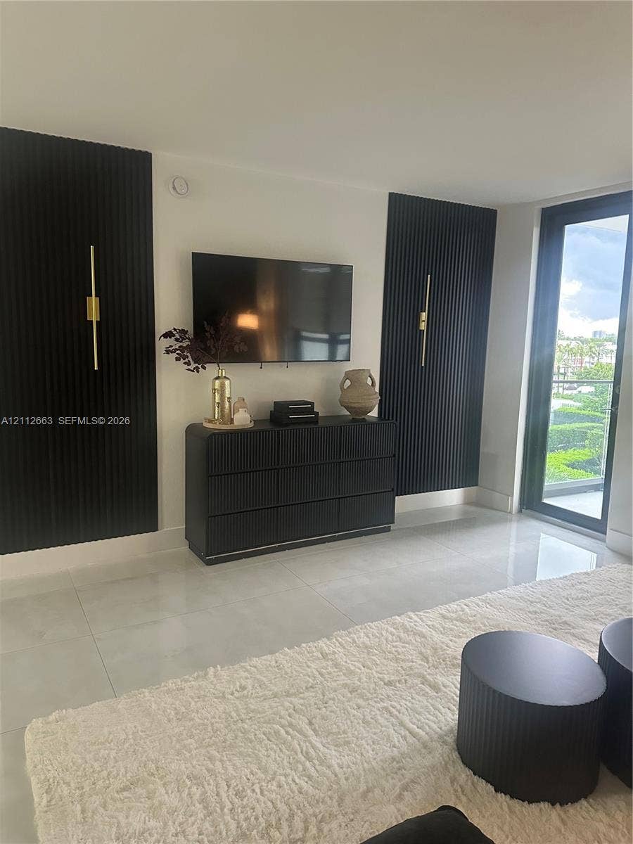 10185 Collins Avenue, #523, Bal Harbour, Bal Harbour, FL 33154 Large-format floor tile, black vertical slat feature wall accents, and slim metallic wall-mounted lighting fixtures