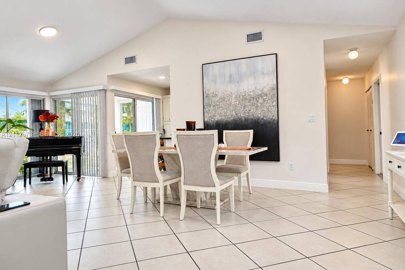 10225 SW 141st Court, #0, Miami, Miami, FL 33186 Vaulted ceilings, large-format diagonal tile flooring, and multiple sliding glass doors featuring vertical blinds