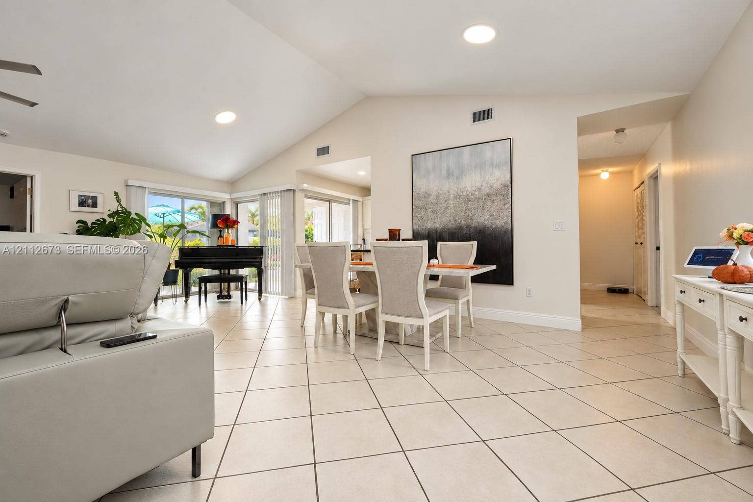 10225 SW 141st Court, #0, Miami, Miami, FL 33186 Vaulted ceilings, large-format tile flooring, recessed lighting, and multiple sliding glass door sets