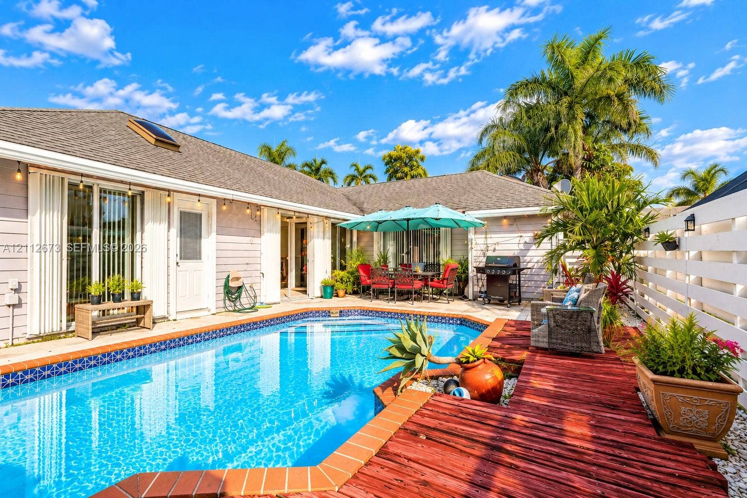 10225 SW 141st Court, #0, Miami, Miami, FL 33186 In-ground swimming pool with tile border, wood-finish decking, and privacy fencing