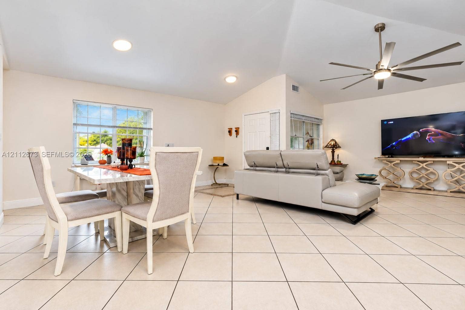 10225 SW 141st Court, #0, Miami, Miami, FL 33186 Open-concept interior featuring vaulted ceilings, oversized tile flooring, recessed lighting, and a multi-blade ceiling fan