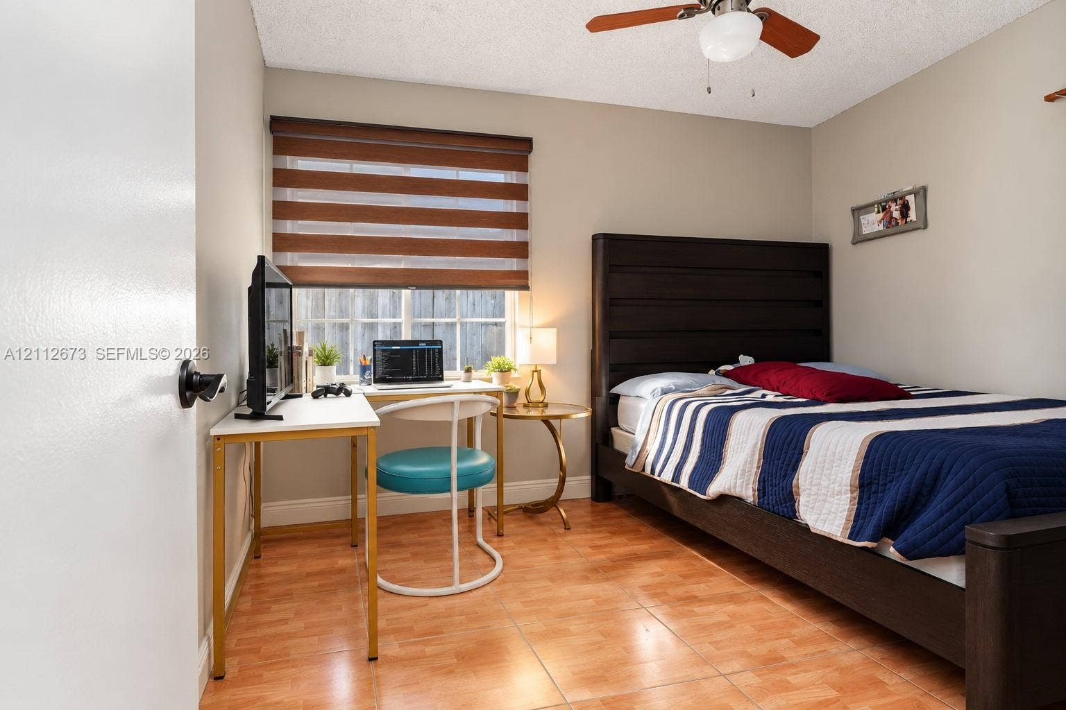 10225 SW 141st Court, #0, Miami, Miami, FL 33186 Room featuring wood-finish tile flooring, a dual-tone fabric window shade, and a ceiling-mounted light fixture with a fan