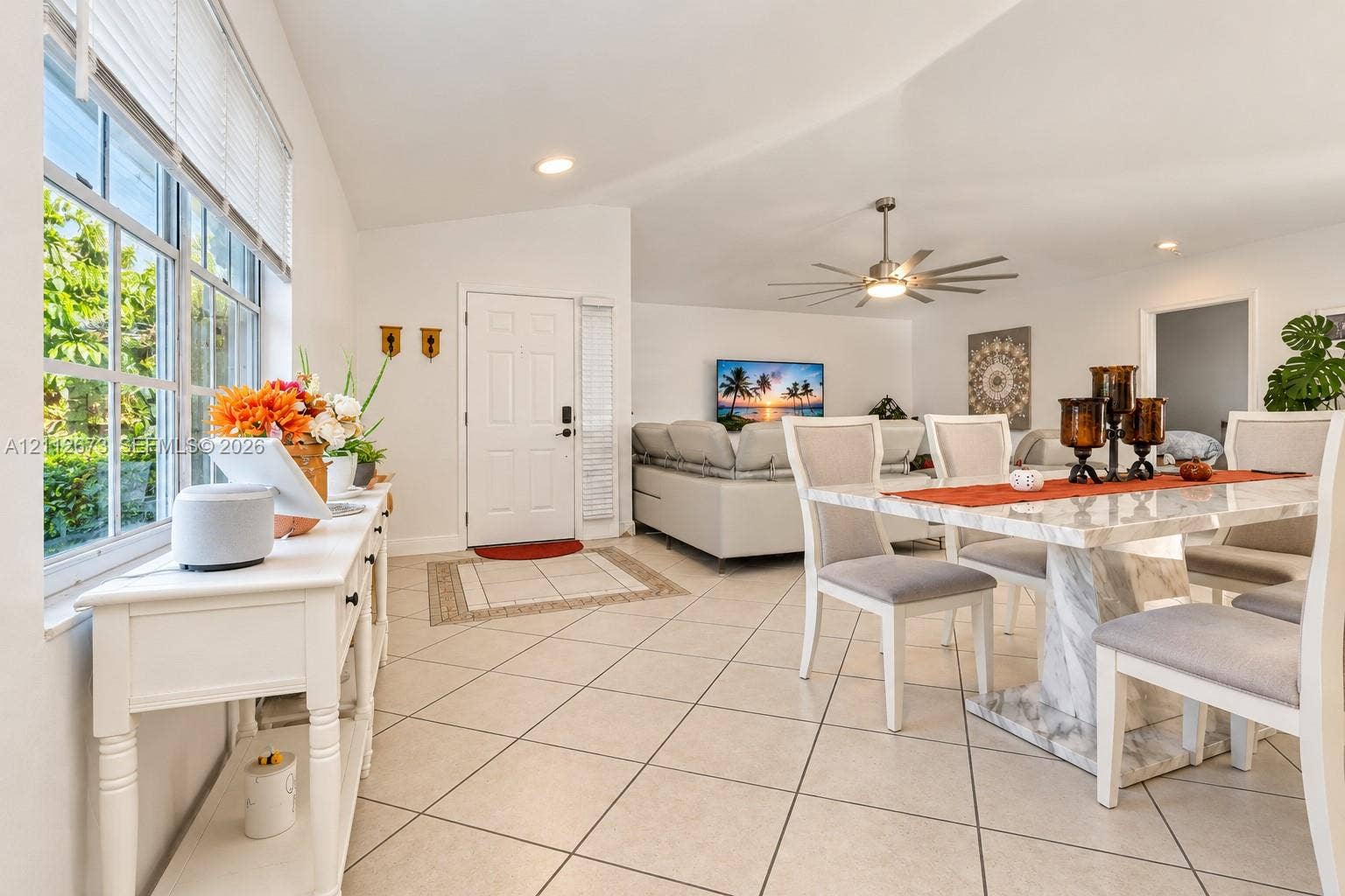10225 SW 141st Court, #0, Miami, Miami, FL 33186 Open-concept area featuring vaulted ceilings, oversized grid-pattern windows, large-format tile flooring, and a multi-blade modern ceiling fan