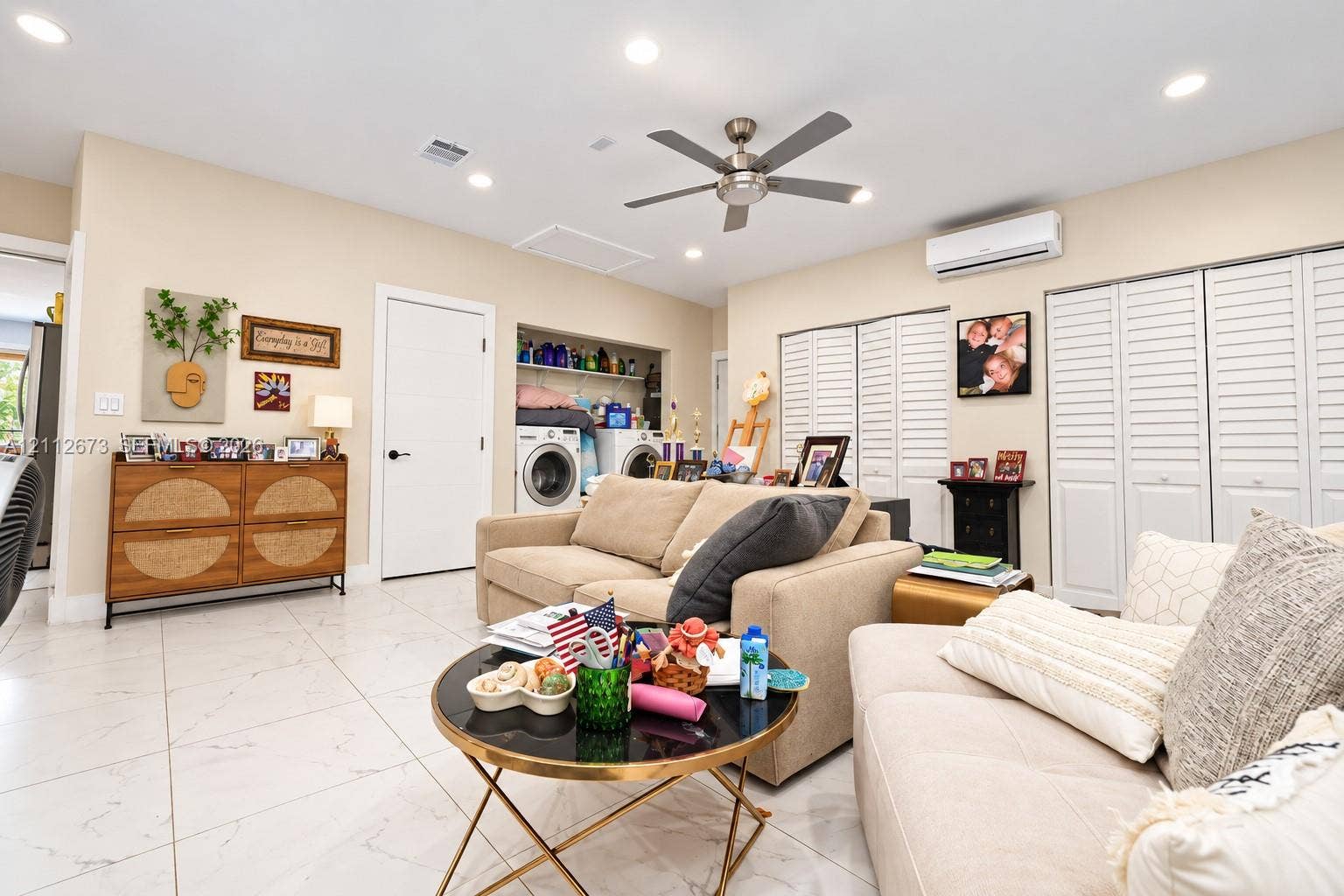 10225 SW 141st Court, #0, Miami, Miami, FL 33186 Large-format tile flooring, recessed ceiling lighting, brushed metal ceiling fan, wall-mounted ductless air conditioning unit, and white louvered bifold closet doors
