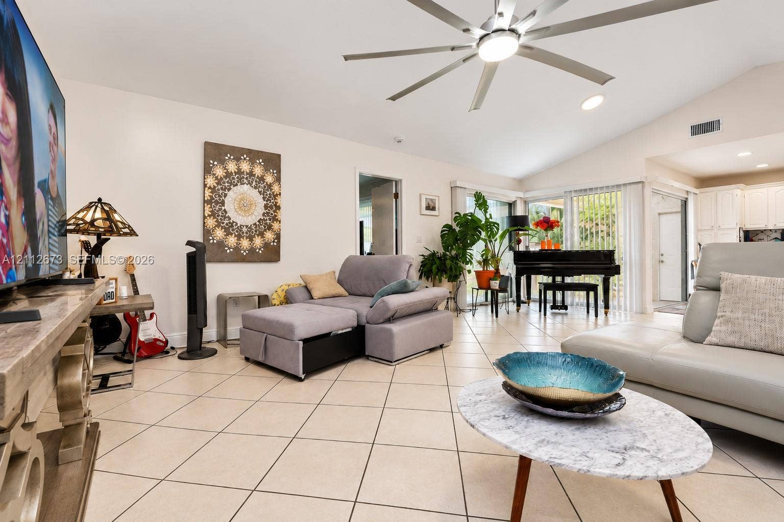 10225 SW 141st Court, #0, Miami, Miami, FL 33186 Living area featuring ceramic tile flooring, vaulted ceilings, and a large multi-blade ceiling fan with integrated lighting