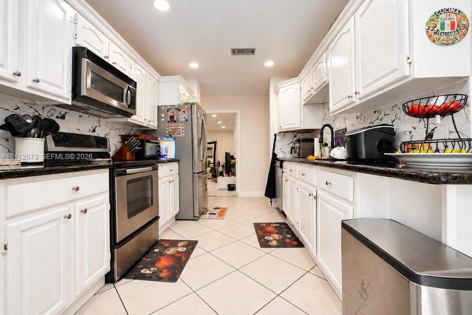 10225 SW 141st Court, #0, Miami, Miami, FL 33186 Kitchen featuring white cabinetry, dark stone-finish countertops, stainless steel appliances, marble-patterned backsplash, and recessed lighting