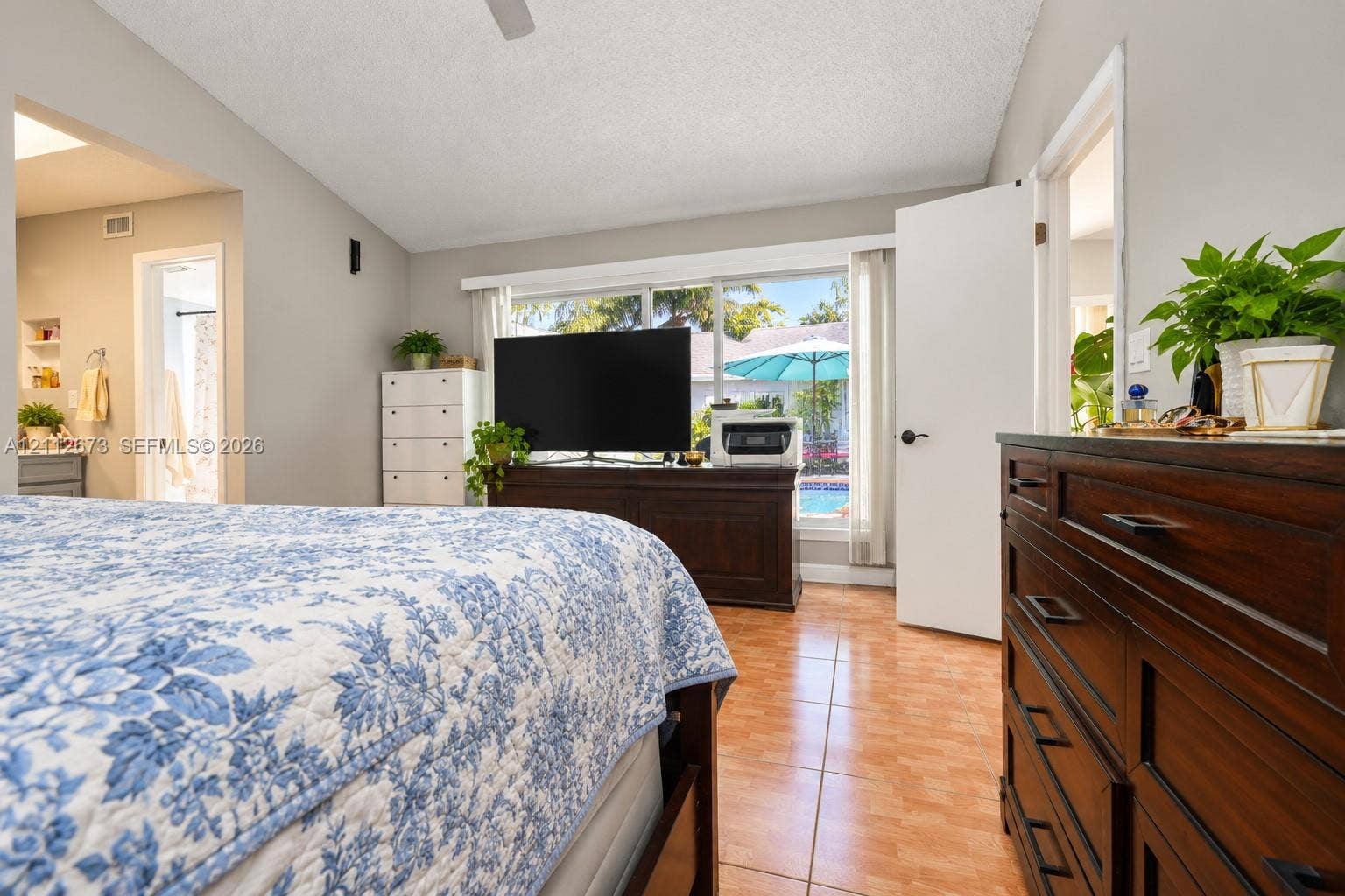 10225 SW 141st Court, #0, Miami, Miami, FL 33186 Vaulted ceiling with a central fan, ceramic tile flooring, and a large horizontal window providing exterior visibility