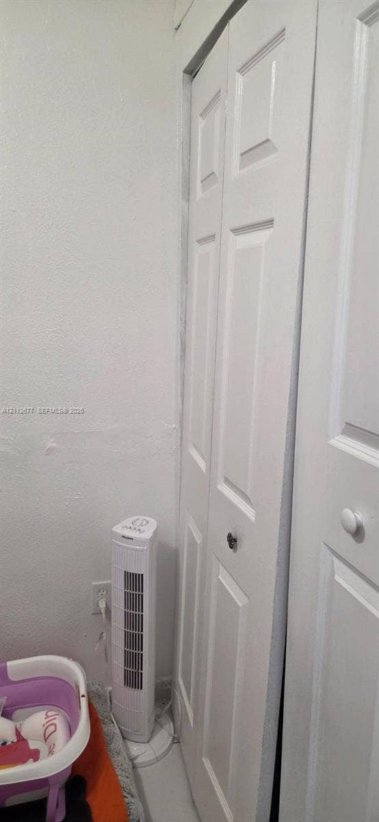 6675 W 4th Avenue, #206, Hialeah, FL 33012 White bi-fold closet doors with round hardware