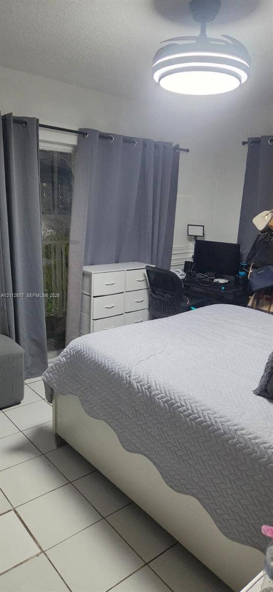 6675 W 4th Avenue, #206, Hialeah, FL 33012 Room featuring white ceramic tile flooring and a modern LED flush-mount ceiling fixture with an integrated fan