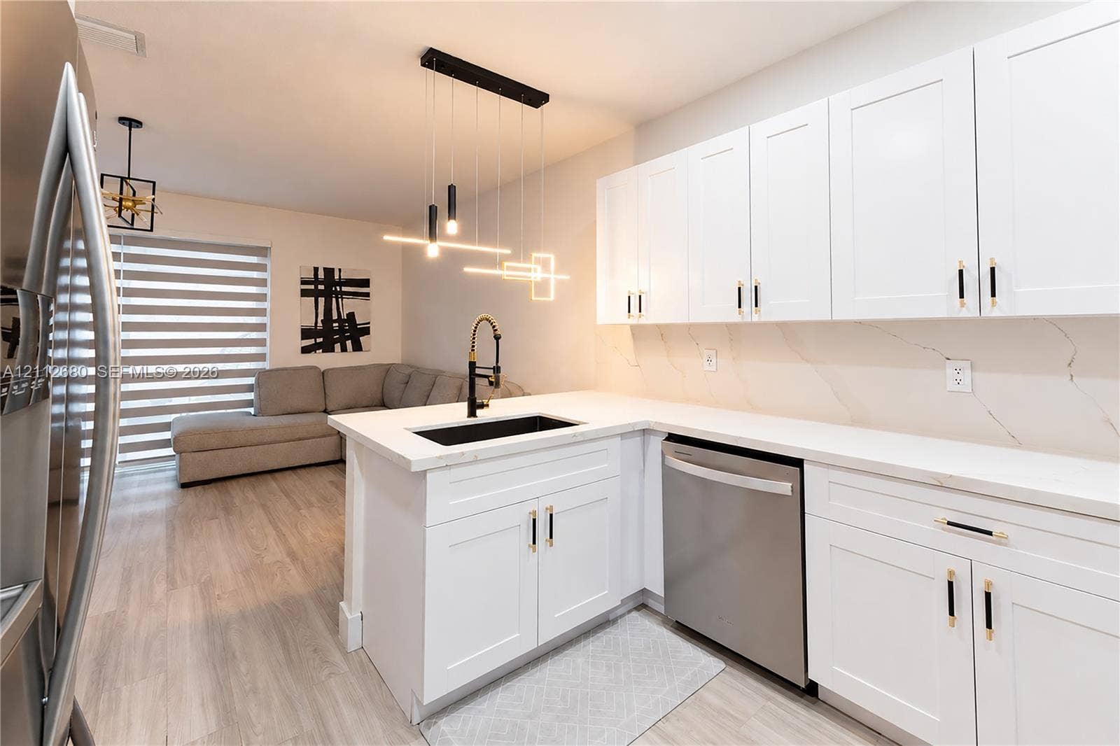 890 SW 154th Path, Miami, FL 33194 Kitchen featuring white shaker-style cabinetry, quartz countertops with integrated backsplash, matte black hardware, stainless steel dishwasher, and modern linear pendant lighting