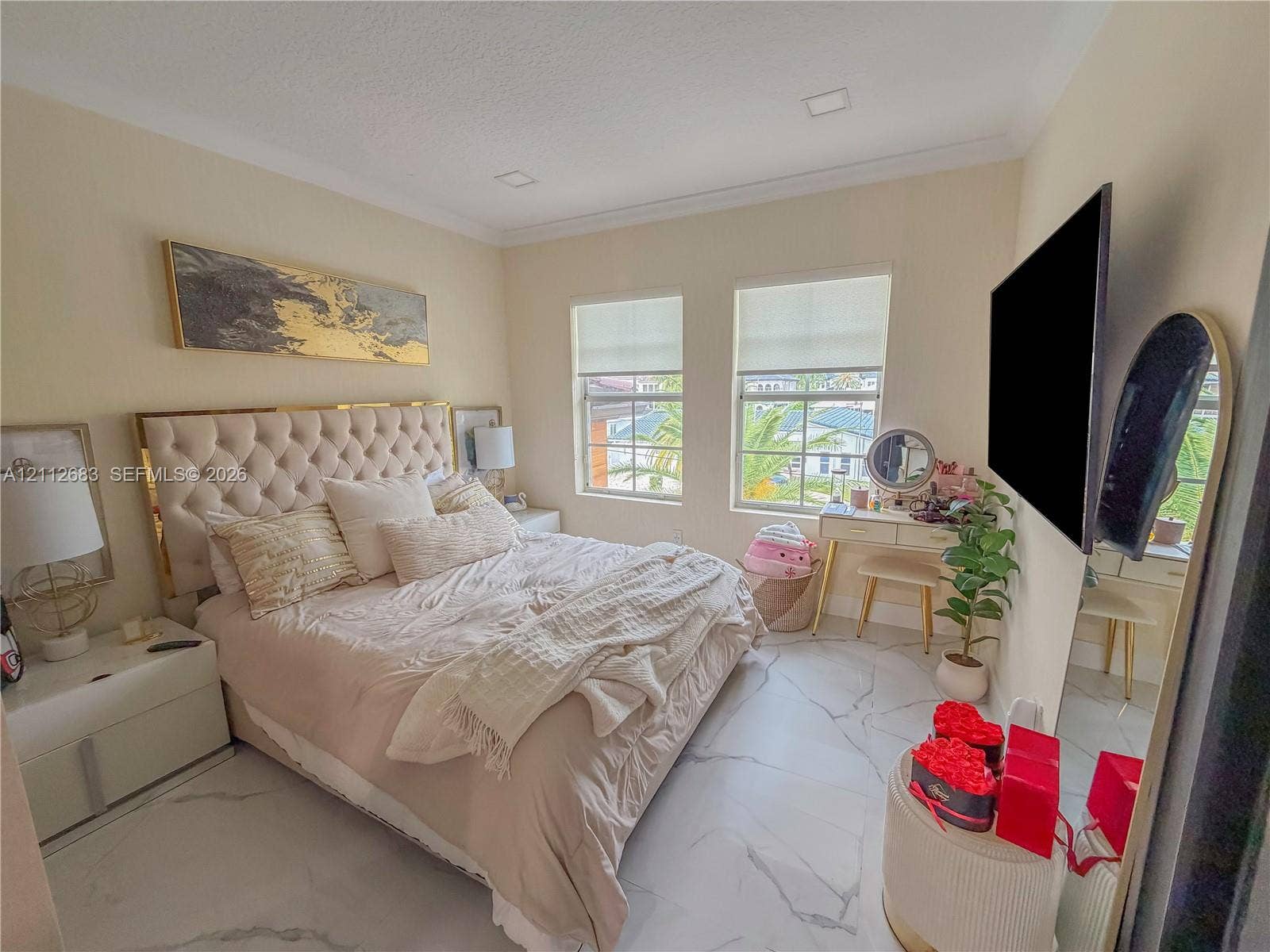 Large-format stone flooring with veining, recessed lighting, and double-pane windows