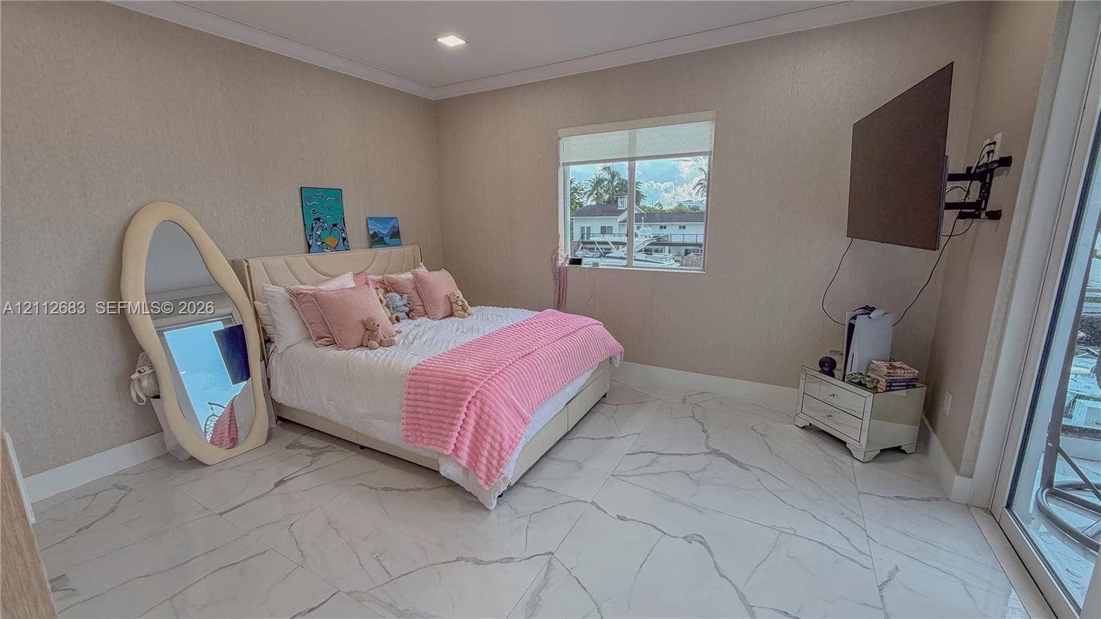 Large-format tile flooring with veining detail, neutral wall texture, recessed ceiling lighting, and floor-to-ceiling glass door