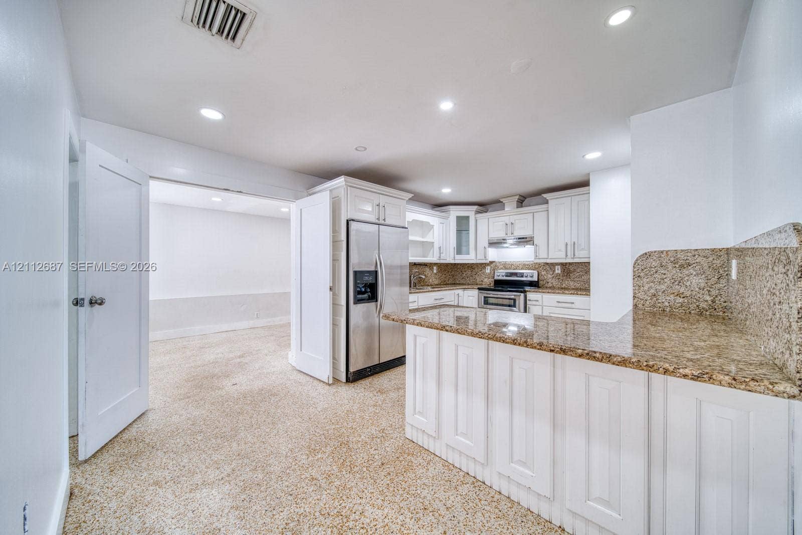 9340 SW 26th Street, Miami, FL 33165 Kitchen featuring white cabinetry, stone-surface countertops, recessed lighting, and stainless steel appliances
