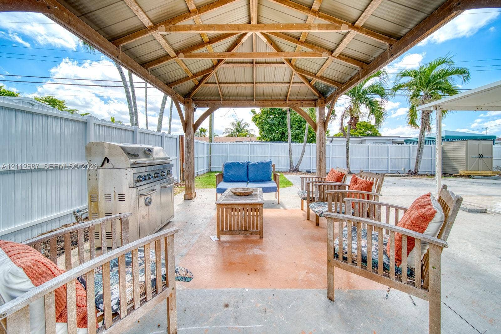 9340 SW 26th Street, Miami, FL 33165 Covered outdoor pavilion featuring heavy timber framing, a metal roof, concrete patio, and built-in stainless steel grill
