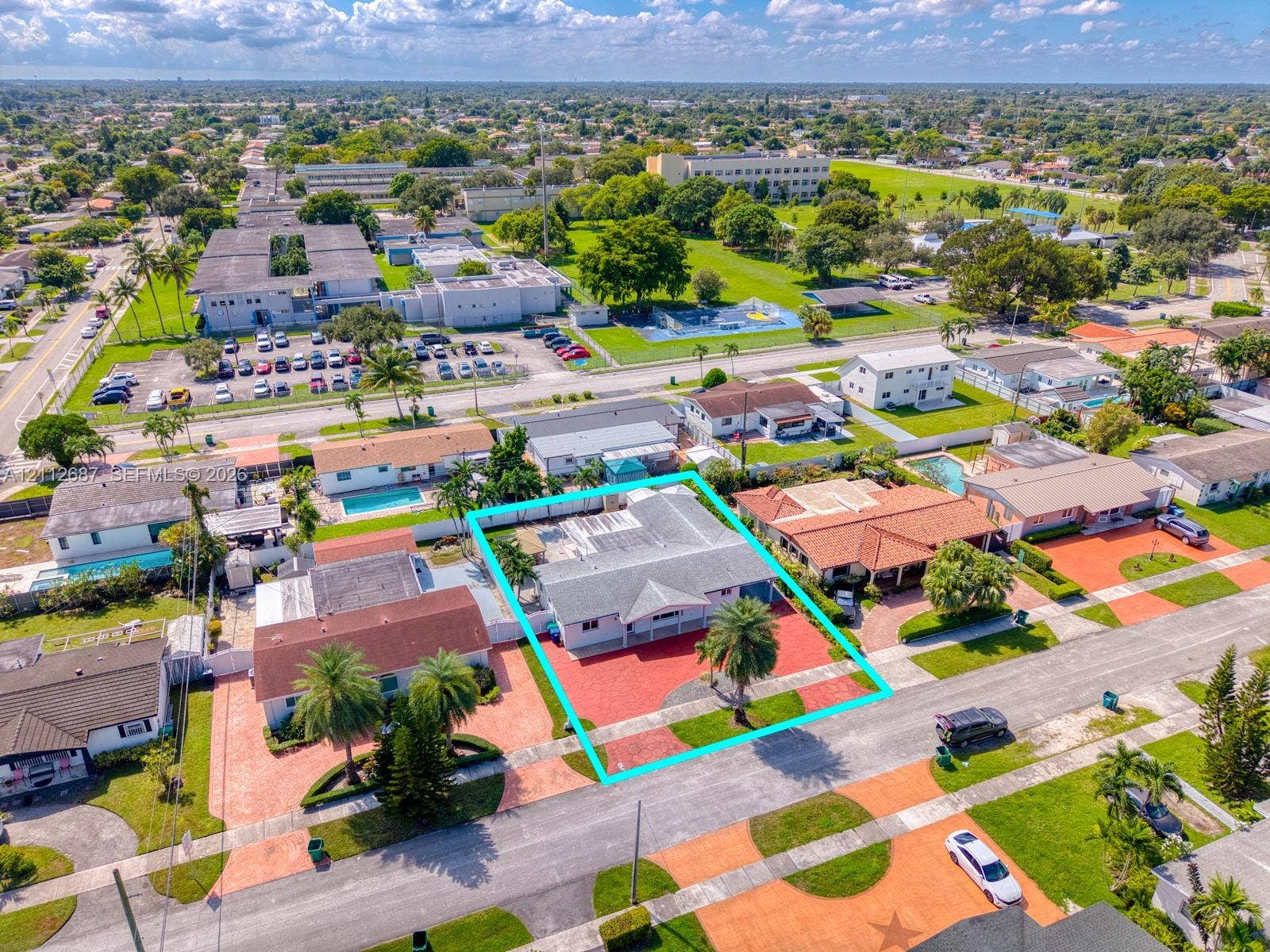 9340 SW 26th Street, Miami, FL 33165 Single-story residence featuring a shingled roof, paver driveway, and mature palm landscaping within a suburban lot