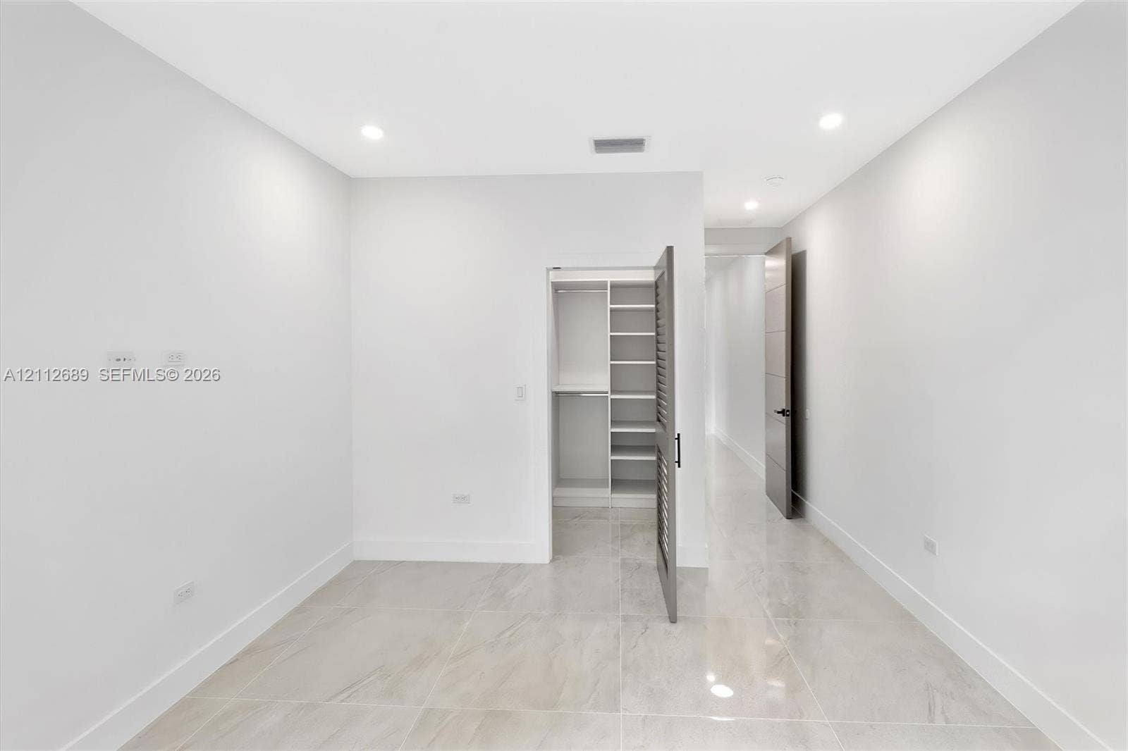 2889 SW 33rd Avenue, #2889, Miami, Miami, FL 33133 Neutral-toned porcelain tile flooring, recessed ceiling lighting, and a walk-in closet featuring built-in shelving