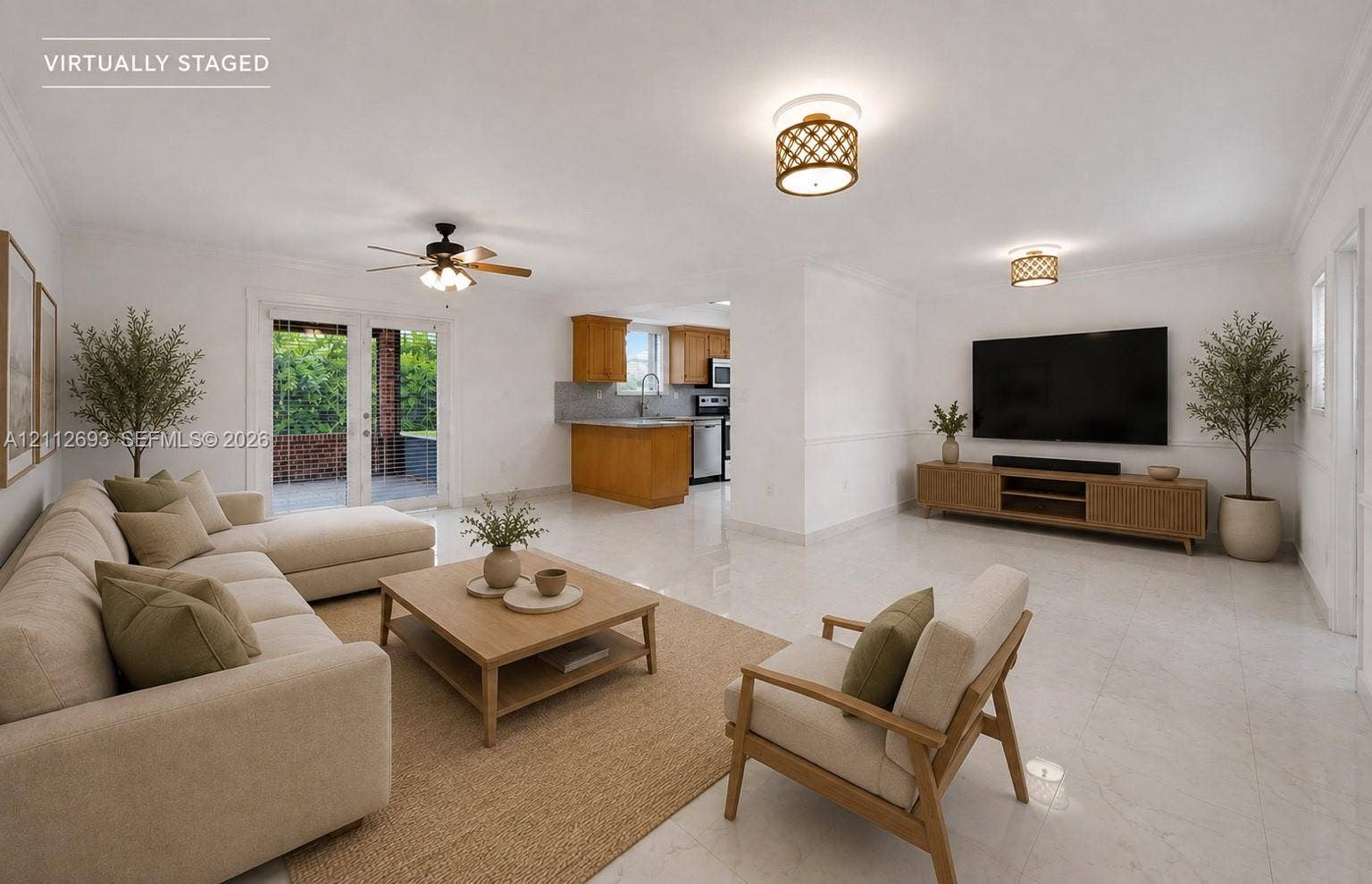 Homestead, Homestead, FL 33033 Open-concept interior featuring light-toned tile flooring, recessed crown molding, ceiling fan with light kit, decorative drum lighting fixtures, and double glass doors