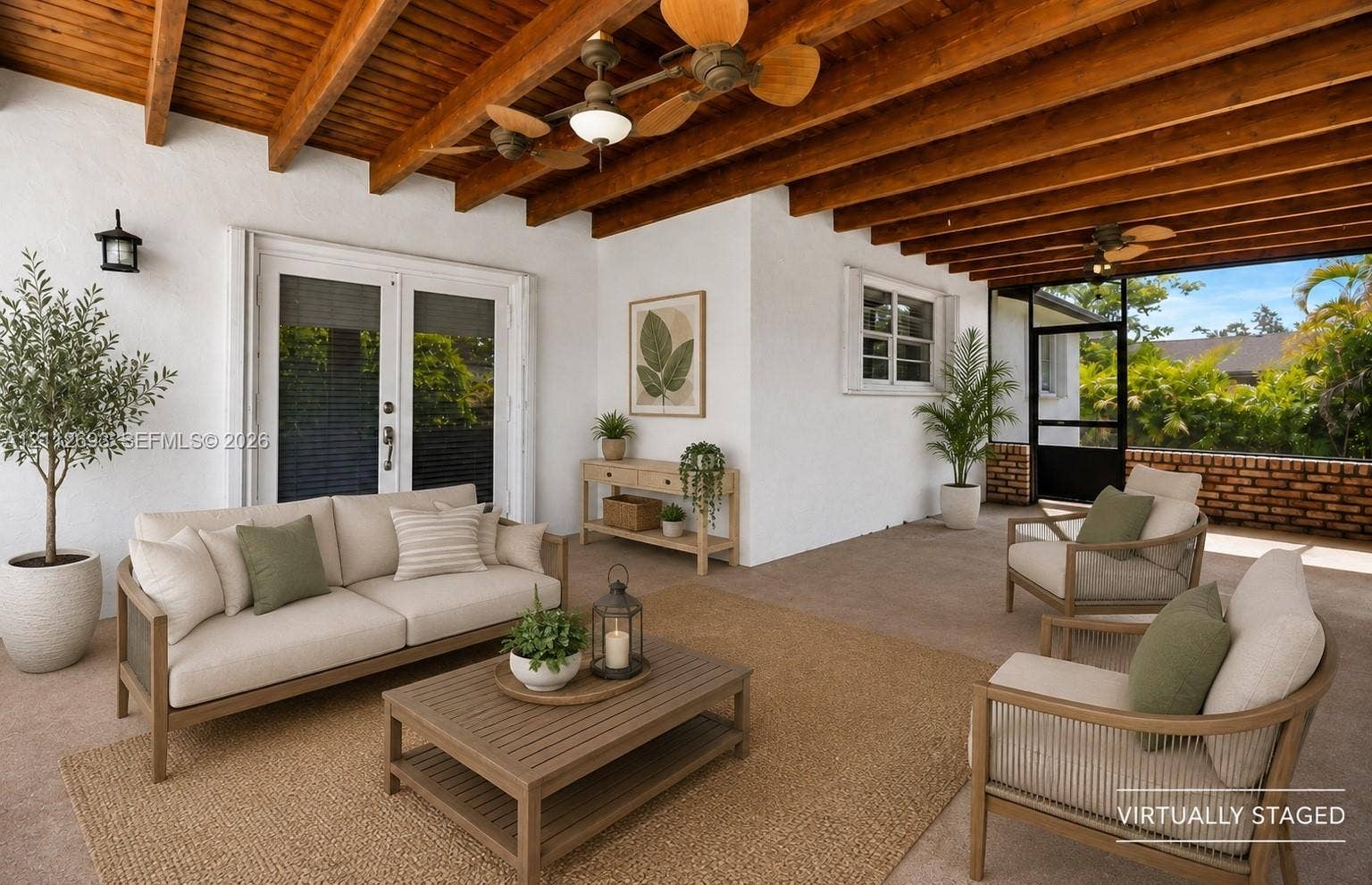 Homestead, Homestead, FL 33033 Covered patio featuring exposed wood beam ceilings, double French doors, dual ceiling fans, wall-mounted light fixtures, and a masonry brick perimeter wall