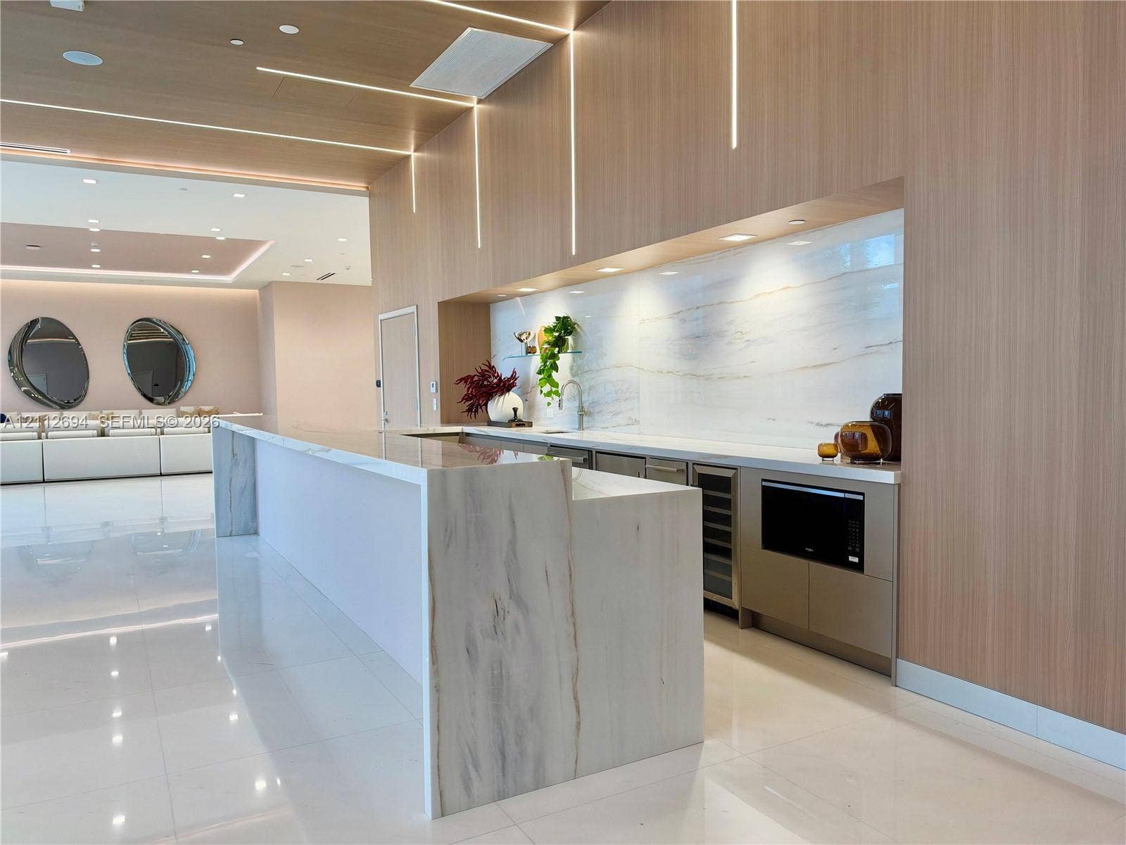 1170 E Hallandale Beach Boulevard, #503, Hallandale Beach, Hallandale Beach, FL 33009 Custom bar area featuring waterfall stone countertops, full-height light wood-tone cabinetry, recessed lighting, integrated beverage refrigerator, and built-in microwave