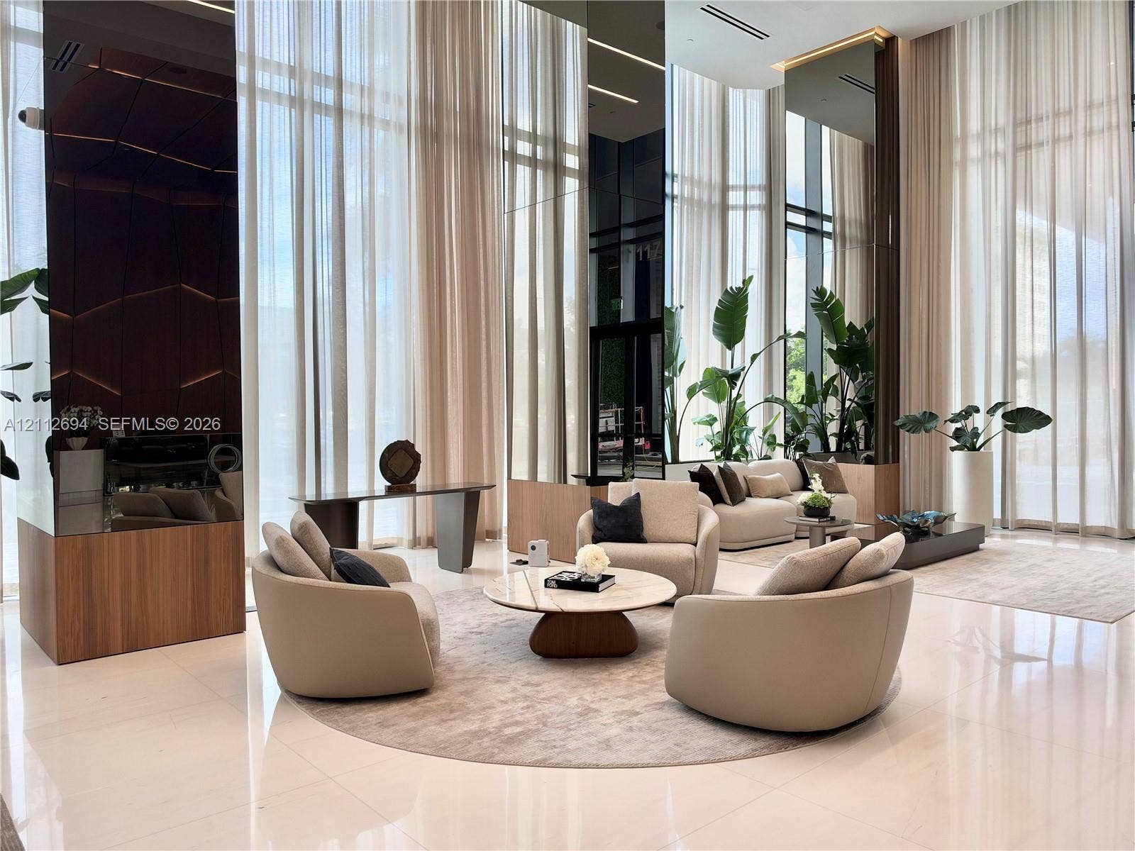 1170 E Hallandale Beach Boulevard, #503, Hallandale Beach, Hallandale Beach, FL 33009 Double-height floor-to-ceiling windows, polished stone flooring, integrated floor-to-ceiling mirror paneling, and wood-finish architectural column cladding