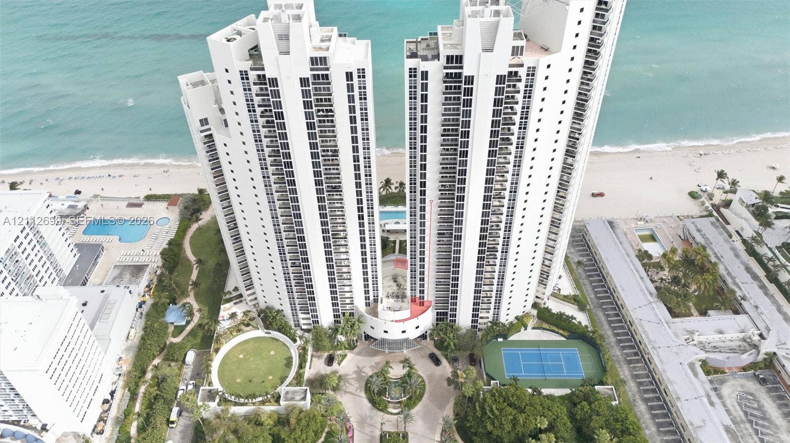 19111 Collins Avenue, #505, Sunny Isles Beach, FL 33160 High-rise residential towers featuring beachfront access, a multi-court tennis facility, and a swimming pool