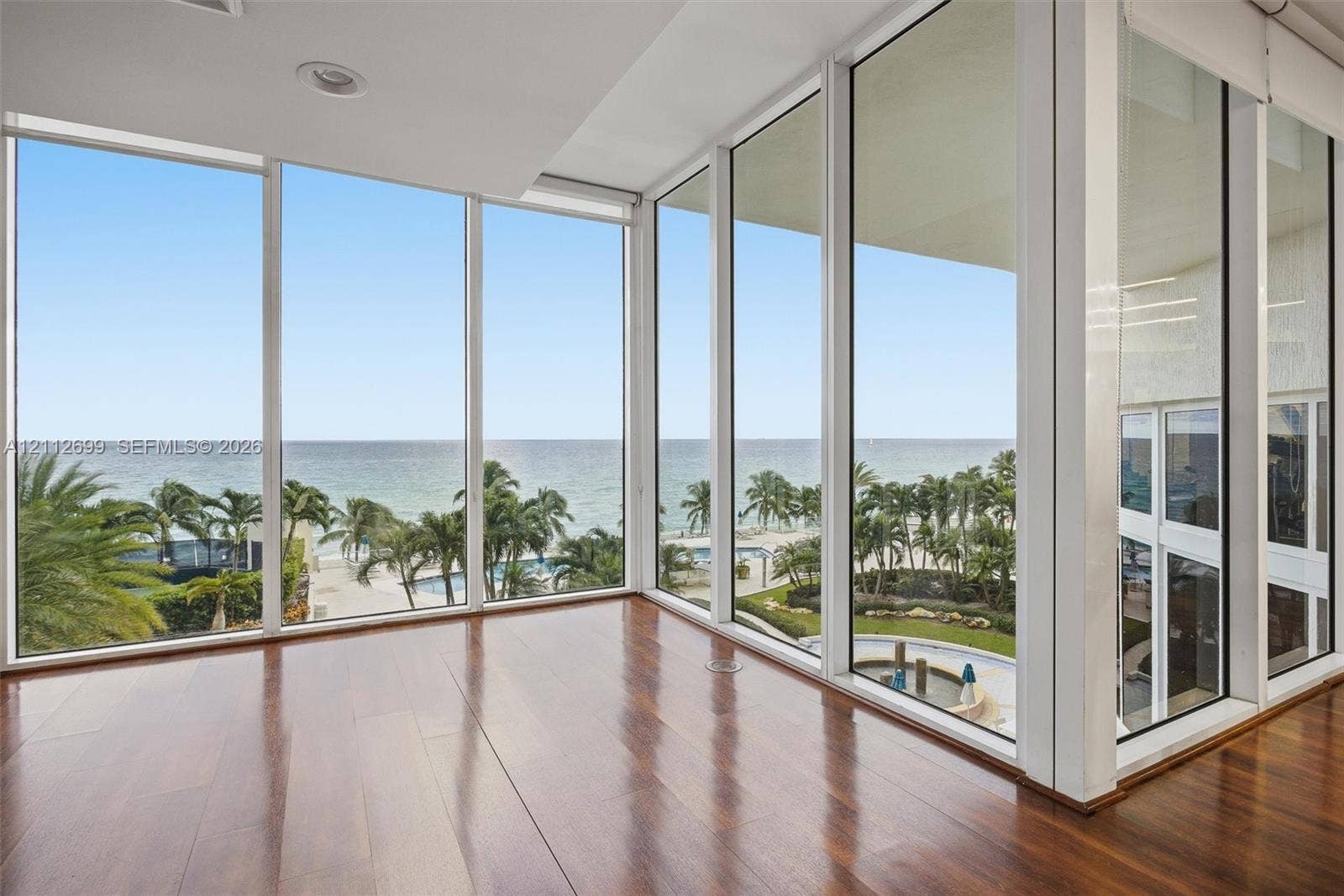 19111 Collins Avenue, #505, Sunny Isles Beach, FL 33160 Floor-to-ceiling glass windows, wood-finish flooring, and recessed lighting