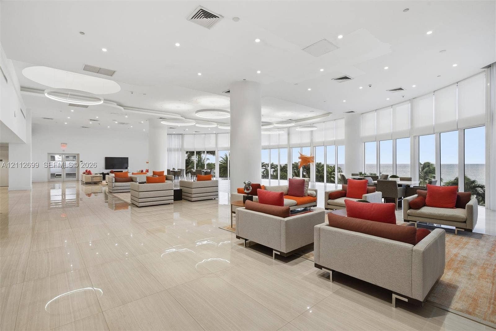 19111 Collins Avenue, #505, Sunny Isles Beach, FL 33160 Expansive open-concept space featuring polished tile flooring, floor-to-ceiling windows, recessed lighting, and integrated circular light fixtures