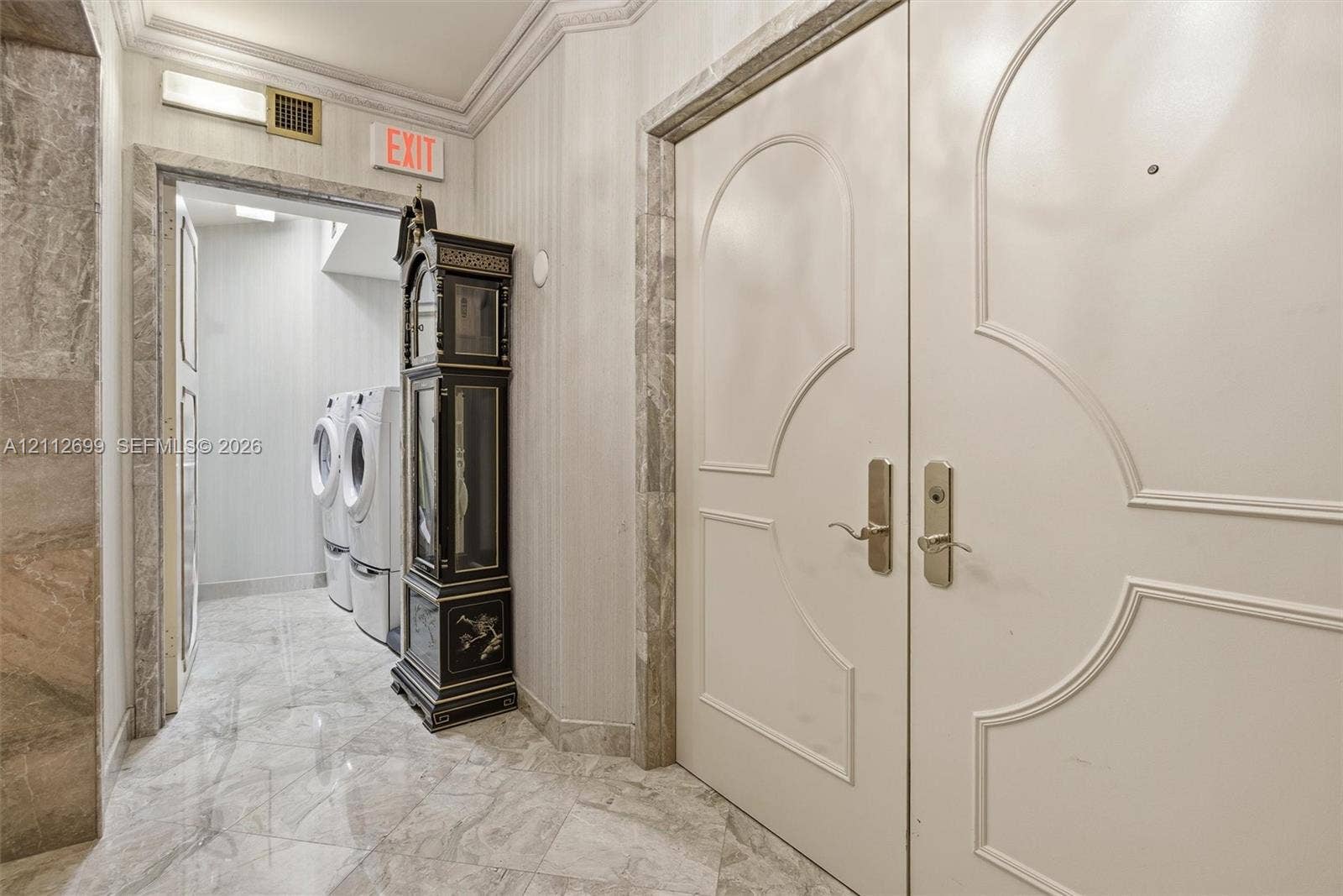 19111 Collins Avenue, #505, Sunny Isles Beach, FL 33160 Double entry doors featuring arched molding, stone flooring, and stone wall trim