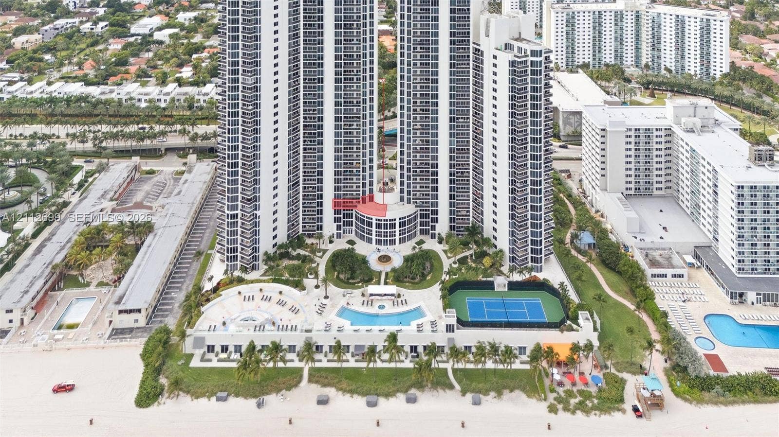 19111 Collins Avenue, #505, Sunny Isles Beach, FL 33160 High-rise coastal property featuring an outdoor swimming pool, tennis court, landscaped grounds, and direct beach access
