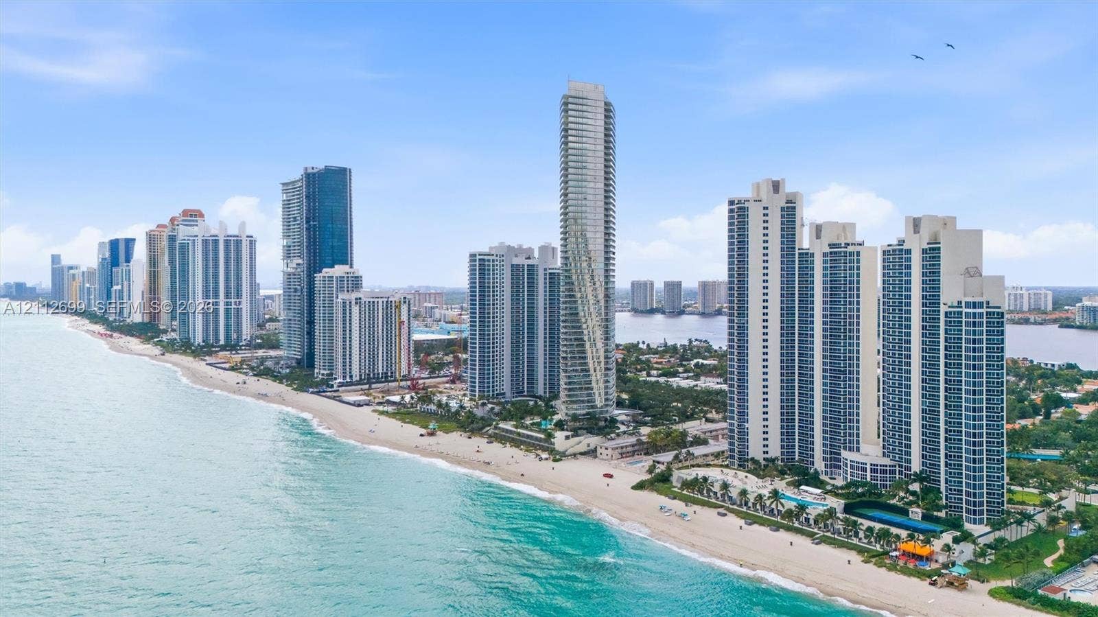 19111 Collins Avenue, #505, Sunny Isles Beach, FL 33160 Aerial perspective of coastal high-rise development featuring direct beach access, proximity to the Atlantic Ocean, and expansive shoreline exposure