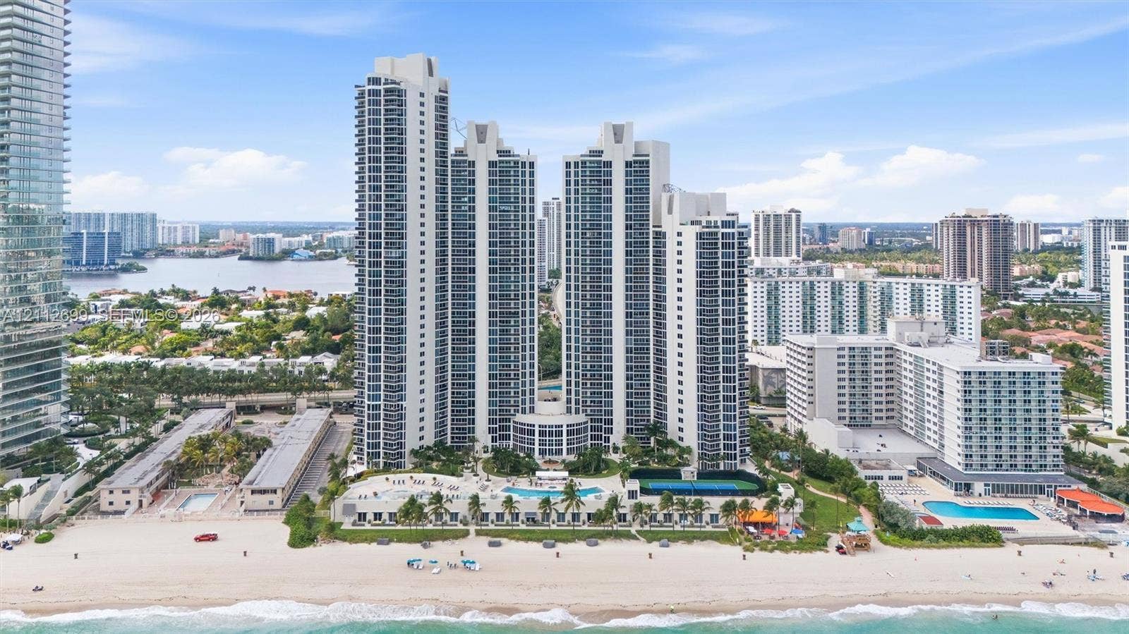 19111 Collins Avenue, #505, Sunny Isles Beach, FL 33160 High-rise residential towers featuring direct beach access, an outdoor swimming pool, tennis courts, and landscaped grounds