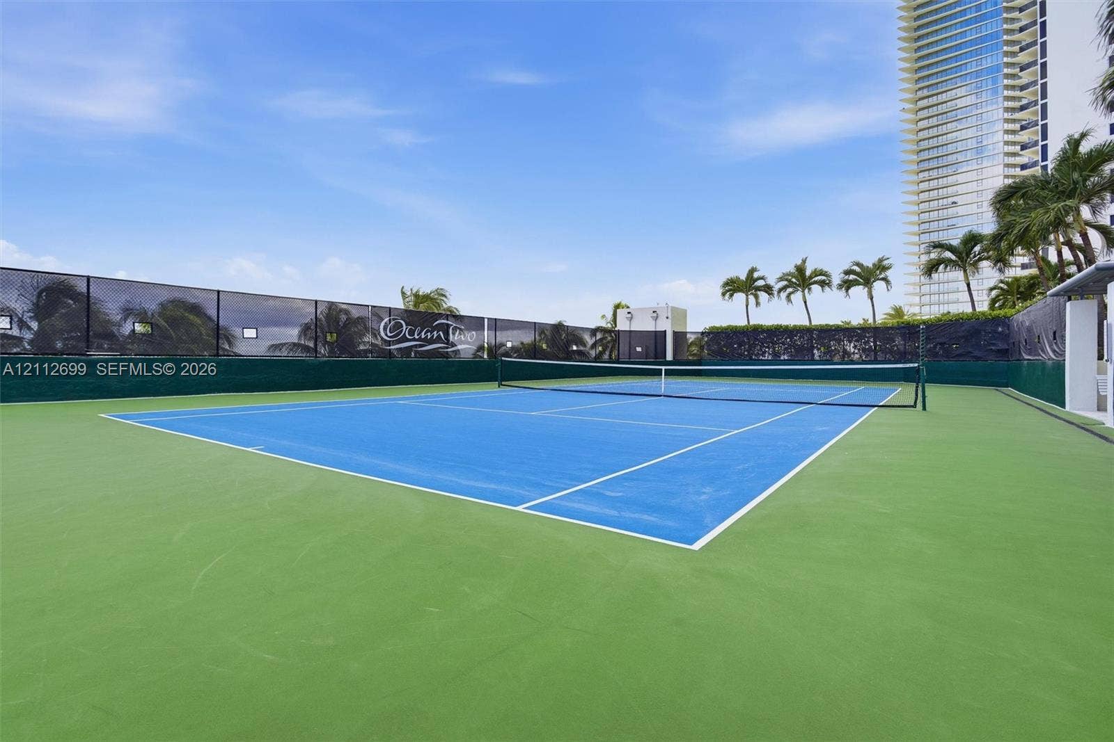 19111 Collins Avenue, #505, Sunny Isles Beach, FL 33160 Tennis court with a dual-toned hard surface, perimeter privacy screening, and professional-grade netting