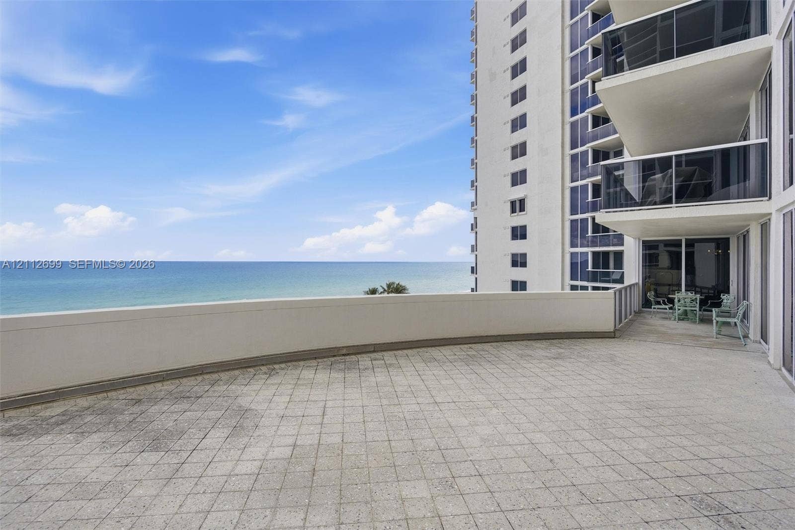 19111 Collins Avenue, #505, Sunny Isles Beach, FL 33160 Expansive Oceanfront terrace featuring tiled flooring, a solid perimeter wall, and direct ocean exposure and breathtaking Sunrise views.
