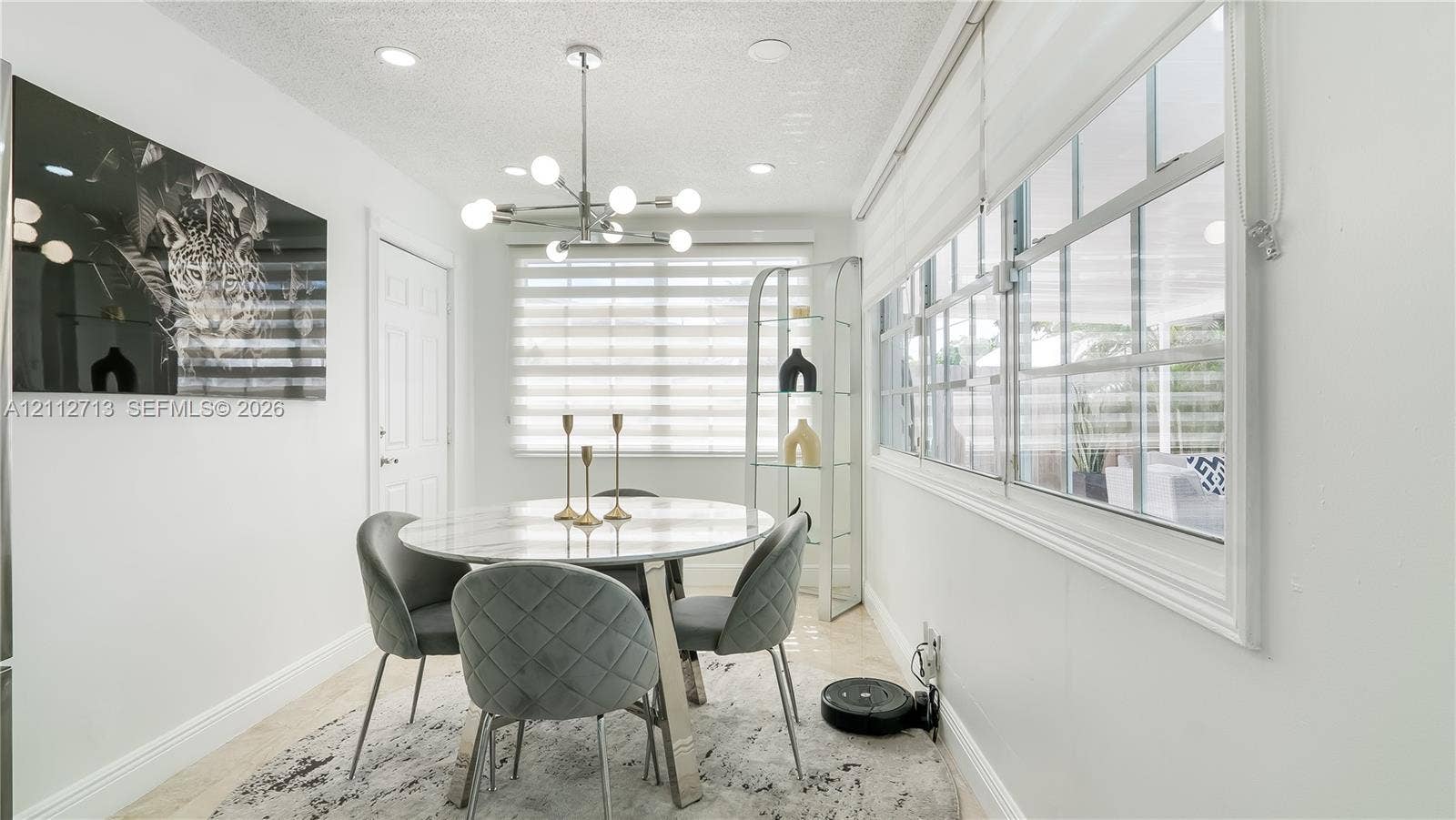 Dining area featuring recessed lighting, a modern multi-bulb chandelier, large windows with horizontal blinds, and tile flooring