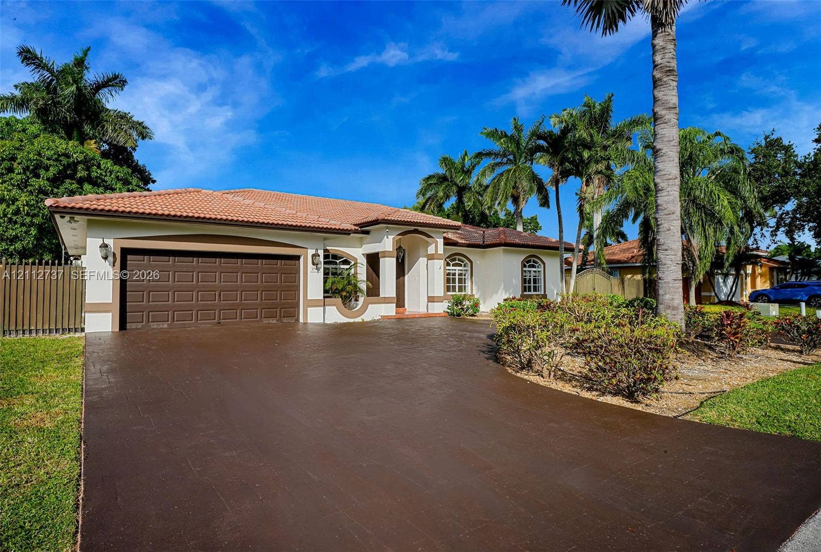 27902 SW 159th Court, Homestead, FL 33031 Single-story residence featuring a tile roof, stucco exterior, two-car garage, and a paved driveway