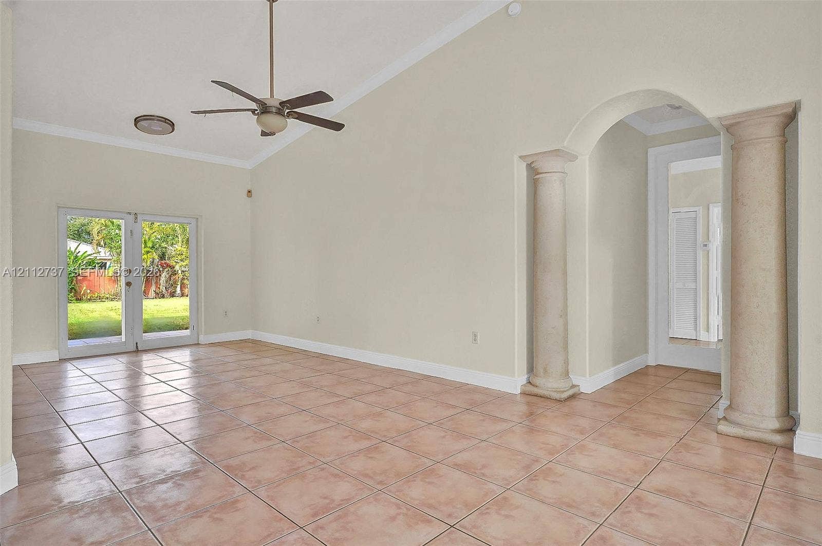 27902 SW 159th Court, Homestead, FL 33031 Vaulted ceilings, large-format tile flooring, double-door glass entry to the exterior, and decorative architectural columns framing the entryway