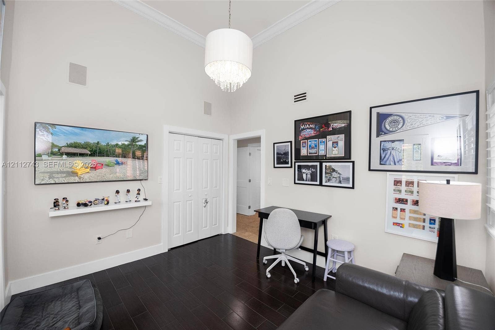 6157 Paradise Point Drive, Palmetto Bay, FL 33157 High vaulted ceilings featuring crown molding, dark wood-finish flooring, and a crystal drum chandelier