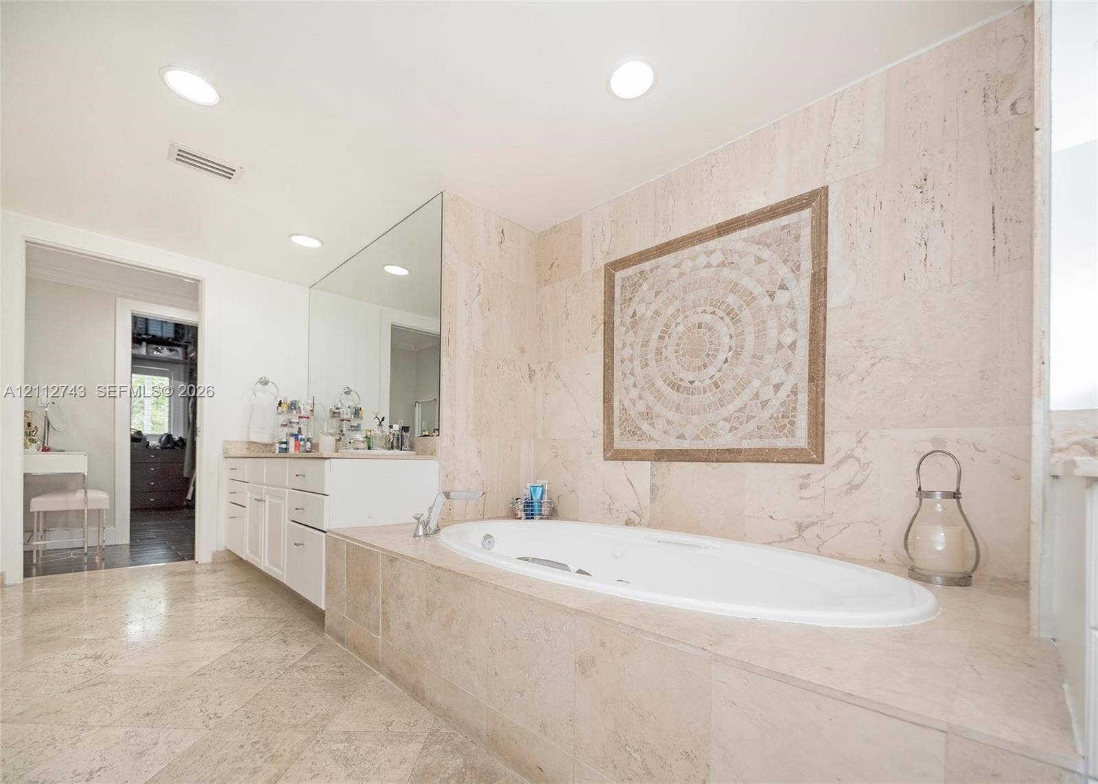 6157 Paradise Point Drive, Palmetto Bay, FL 33157 Soaking tub with a deck surround featuring stone tile cladding, wall-mounted mosaic tile inlay, recessed lighting, and stone flooring