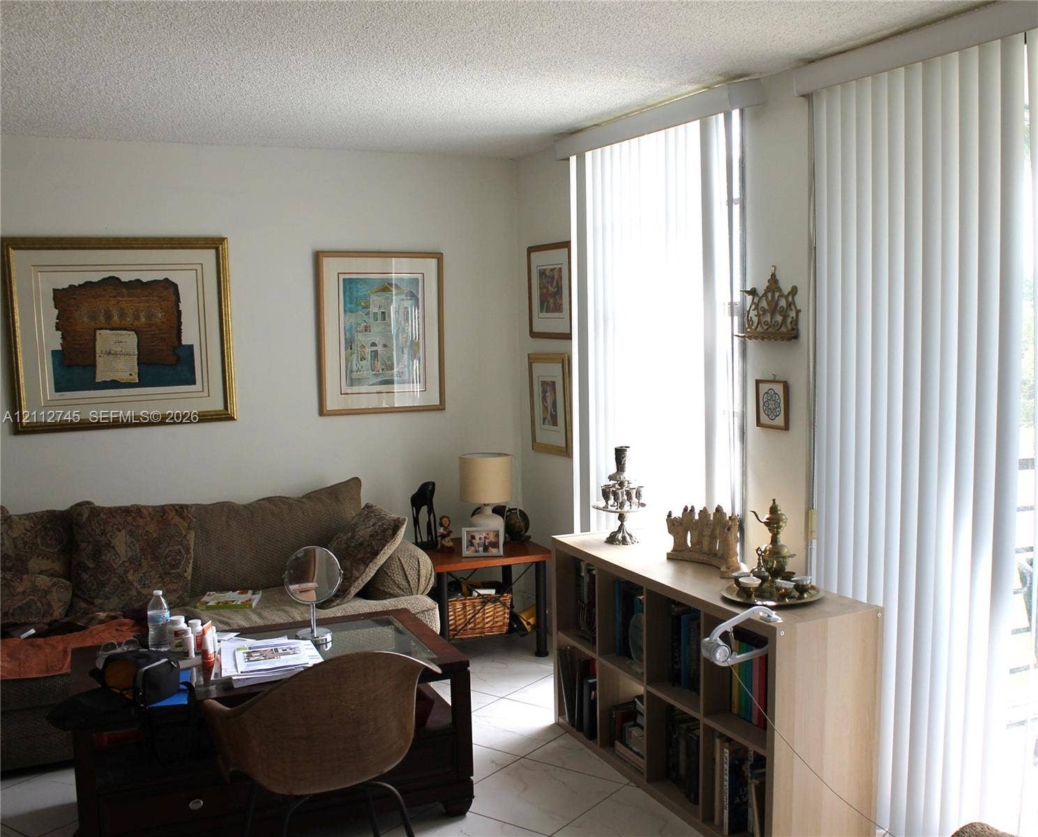 20500 W Country Club Drive, #202, Aventura, FL 33180 Living area featuring light-toned tile flooring, floor-to-ceiling windows, and vertical window treatments